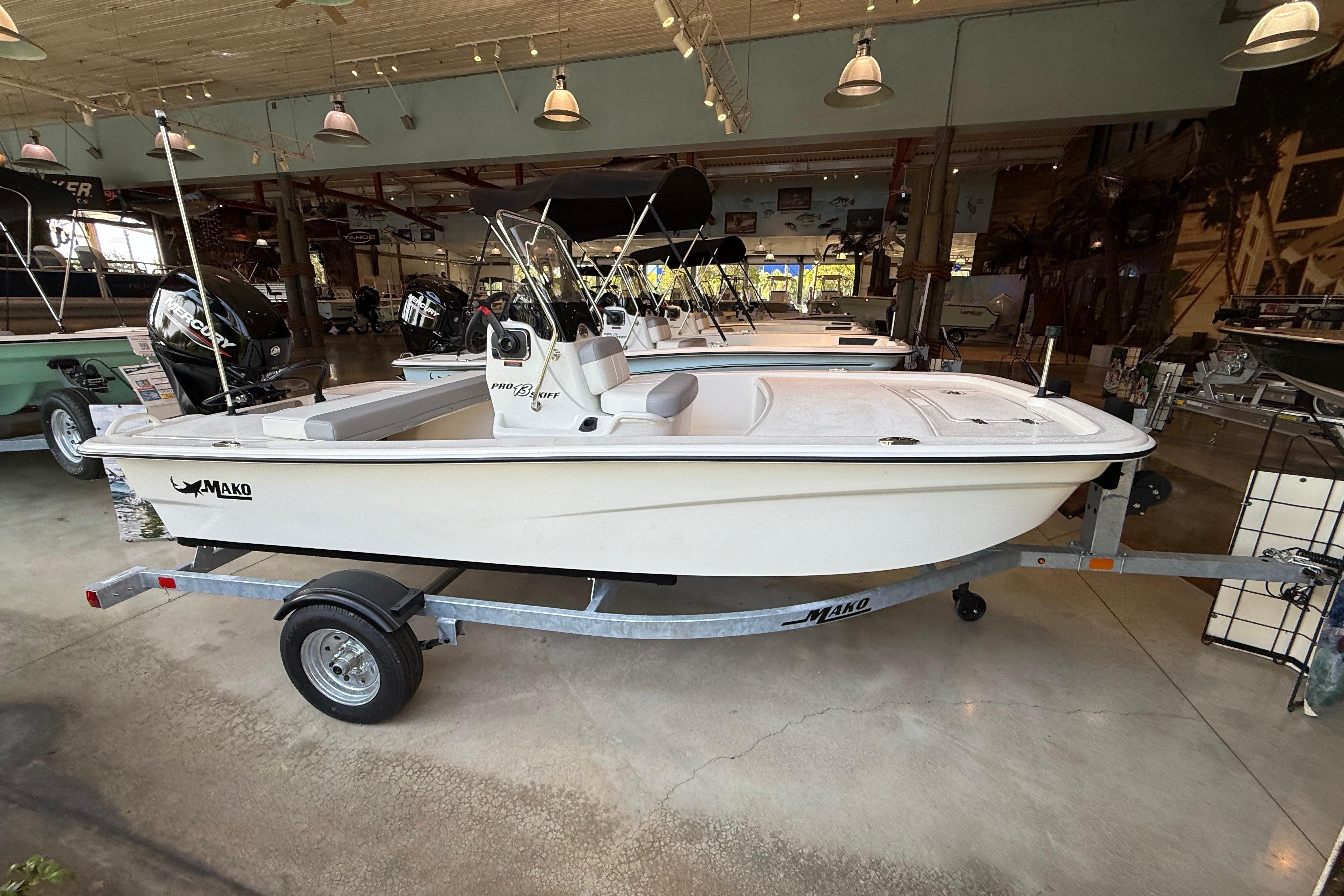 2026 Mako Pro Skiff 13 CC boat displayed in a showroom on a trailer.