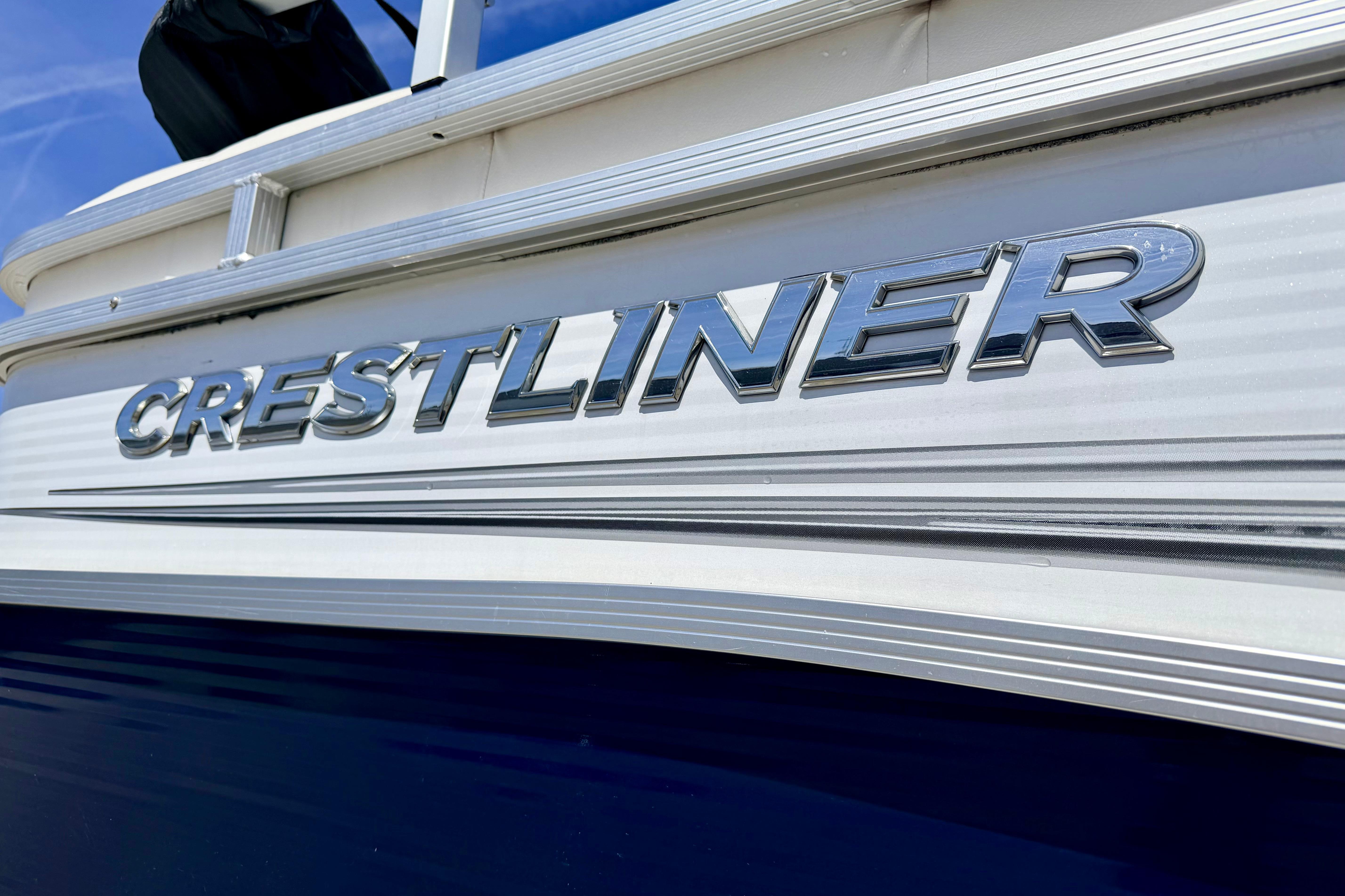 2019 Crestliner 240 Rally DX CW boat with sleek metallic logo on the side.