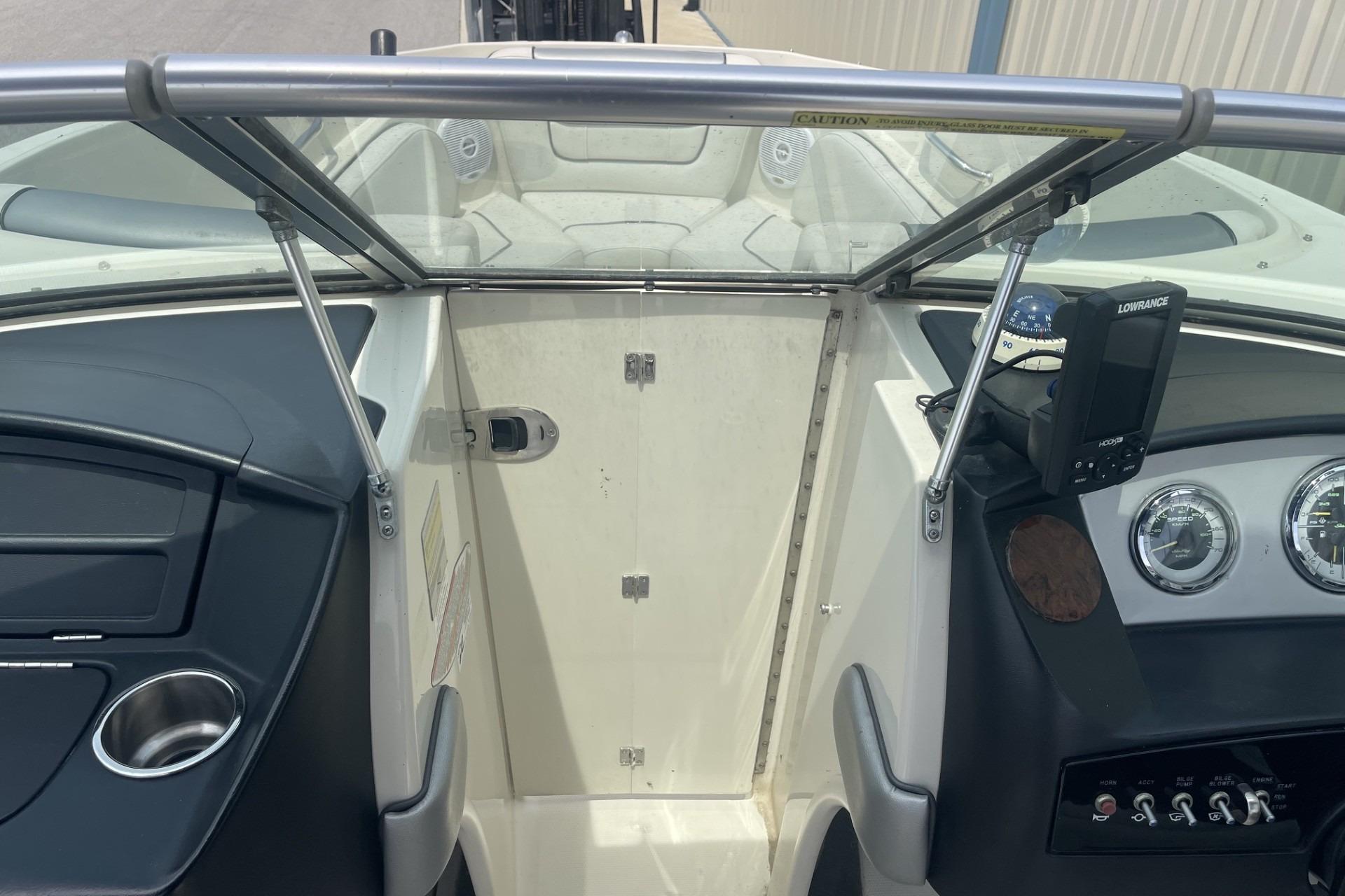 Interior view of a 2010 Sea Ray 230 Bow Rider Select boat dashboard and controls.
