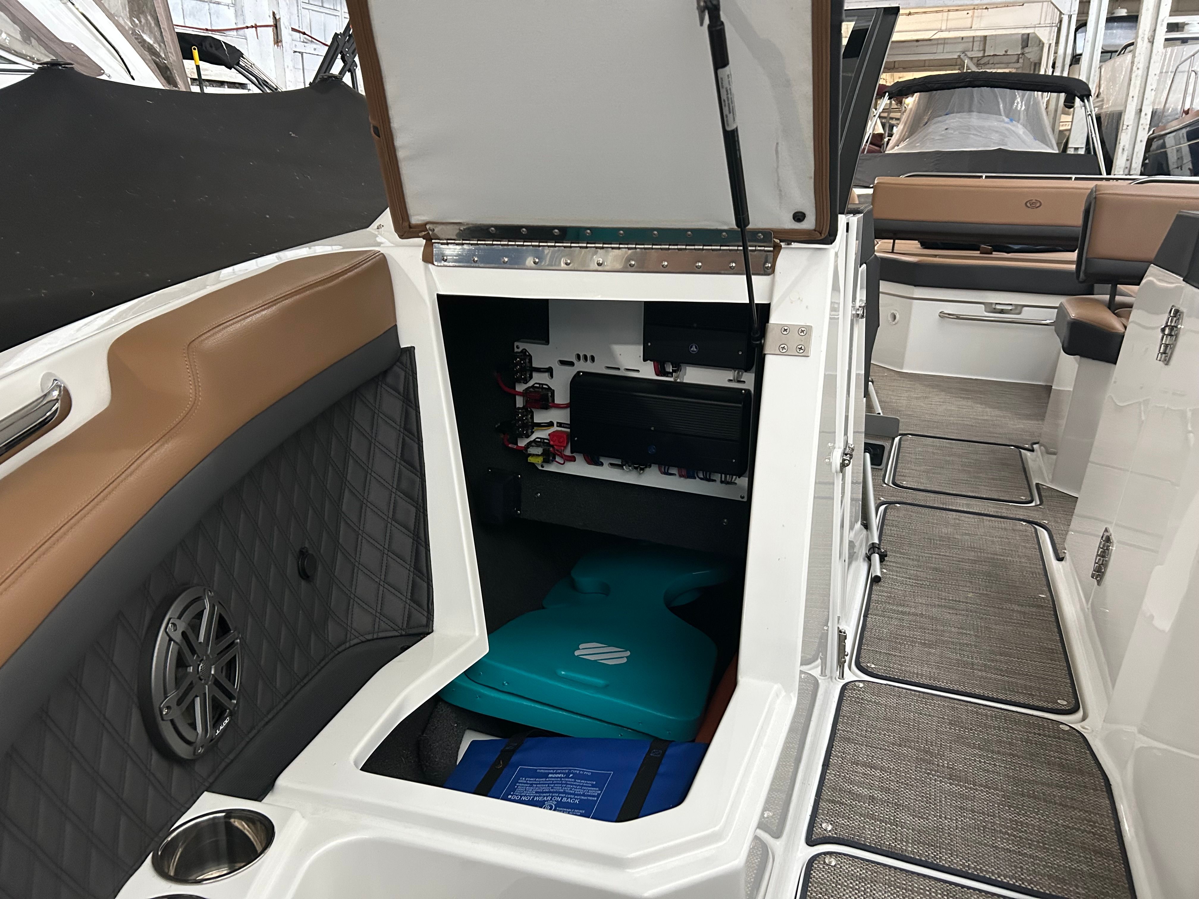 Interior of 2024 Cobalt R6 boat with open storage compartment.