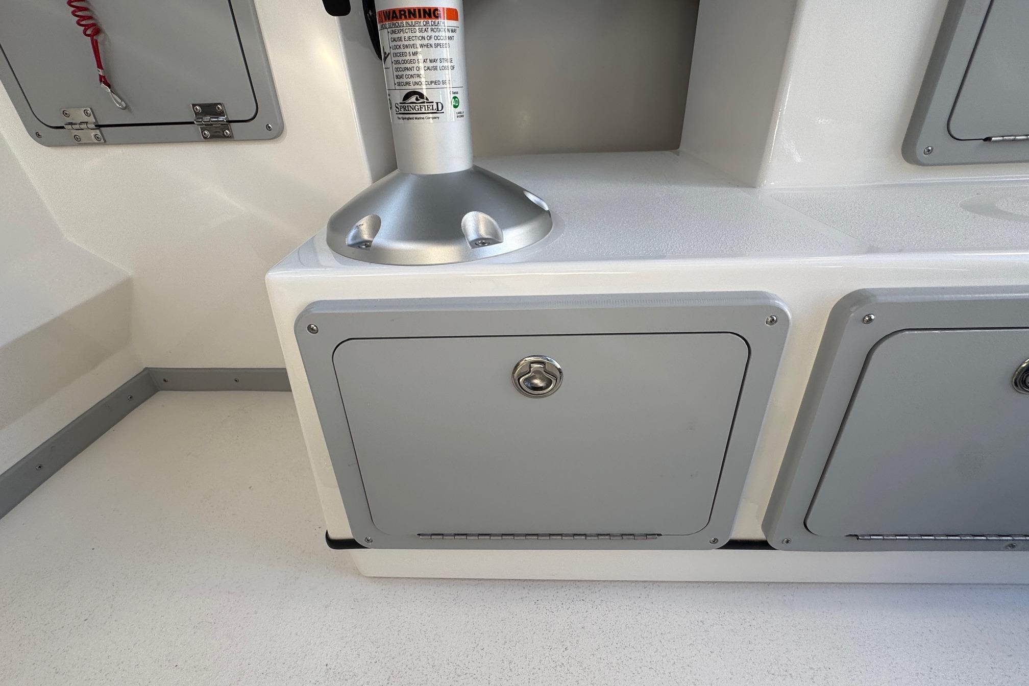 Interior of 2026 Defiance Admiral 250 EX boat with storage compartments.
