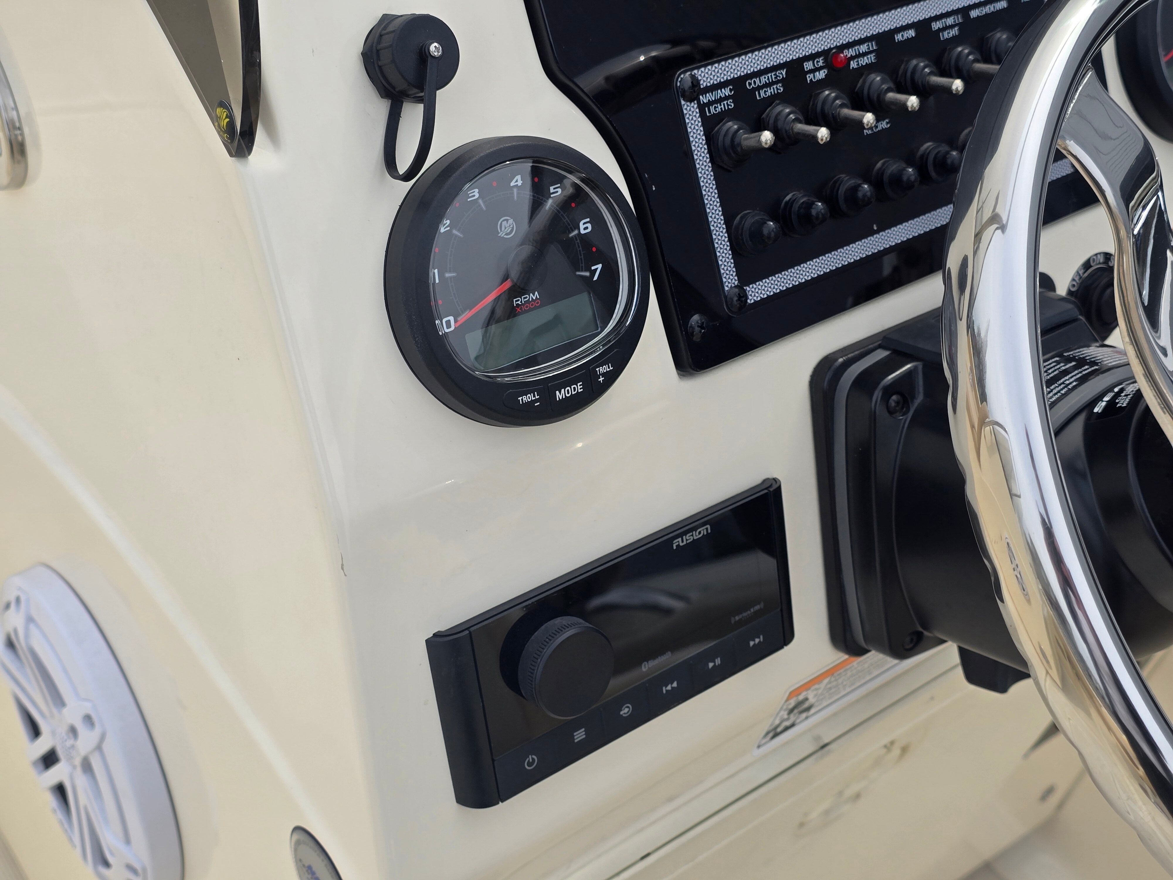 Dashboard of a 2022 Scout 195 Sport Dorado with steering wheel, tachometer, and controls.