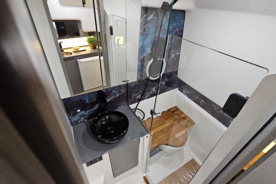 Modern bathroom in 2026 Hanover 327 RV with sleek design and compact amenities.