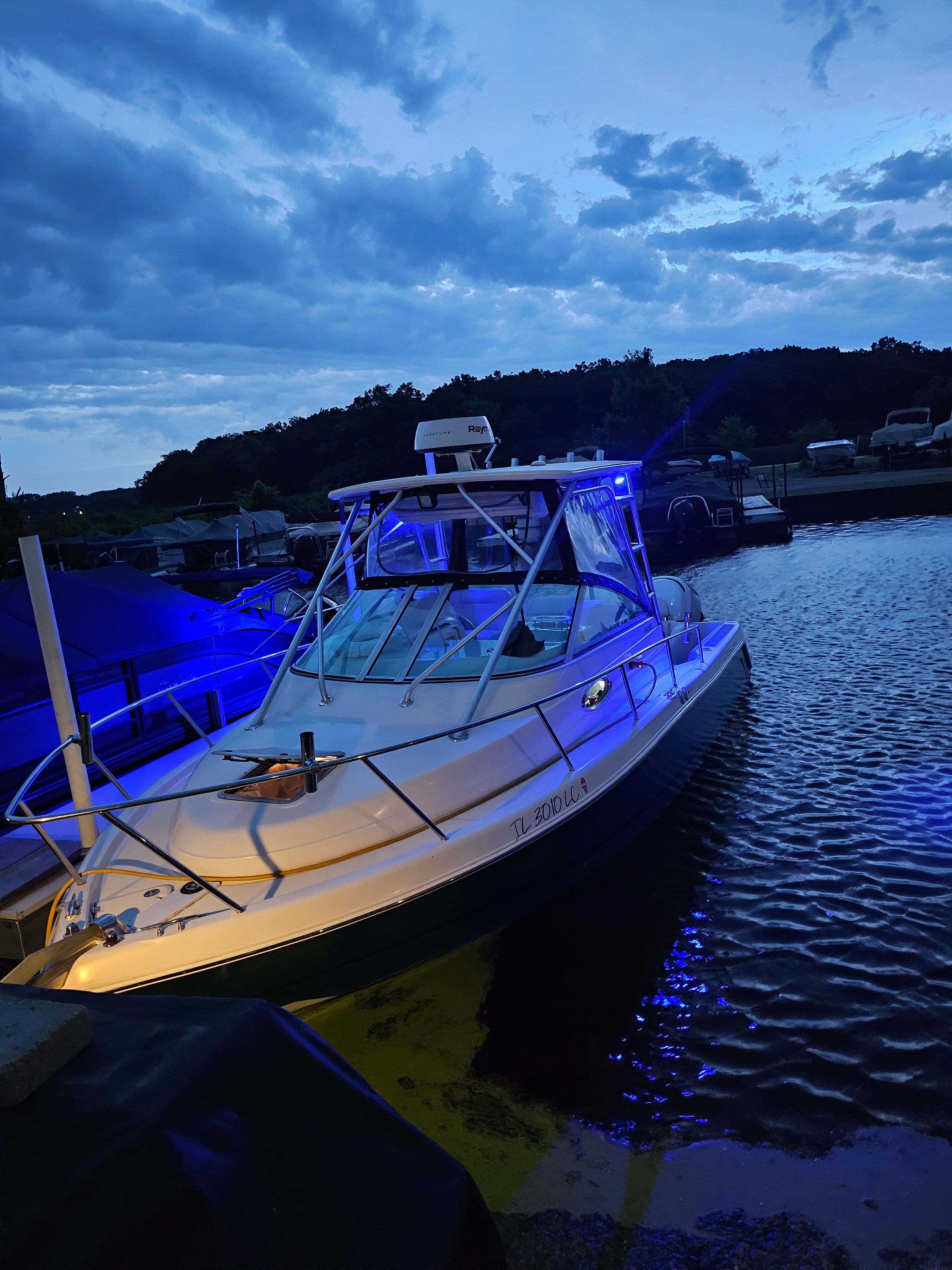 2005 Robalo R265 Walkaround boat at sunset in the harbor.
