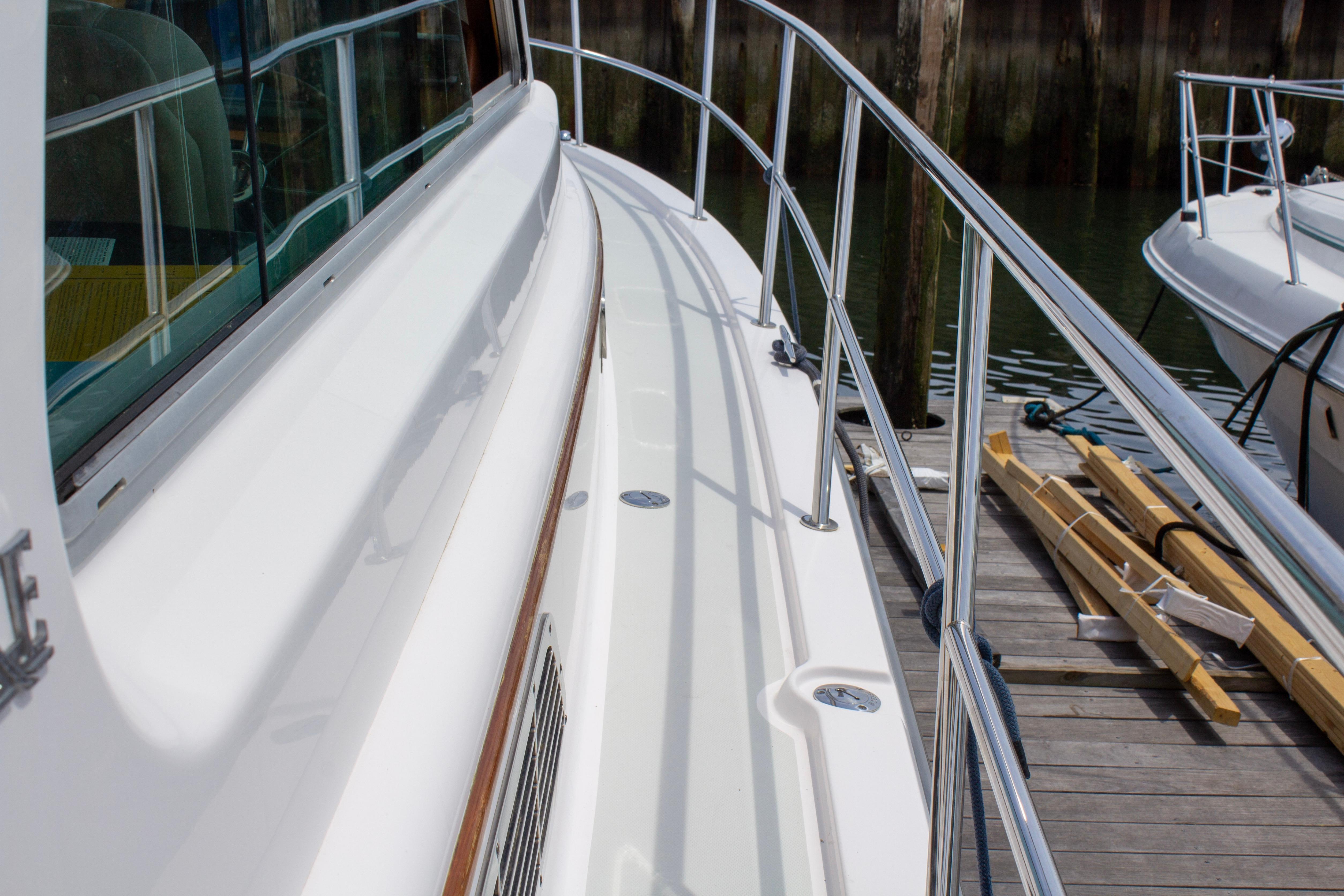 2013 Sabre 38 Salon Express yacht docked, showcasing sleek deck and railing design.