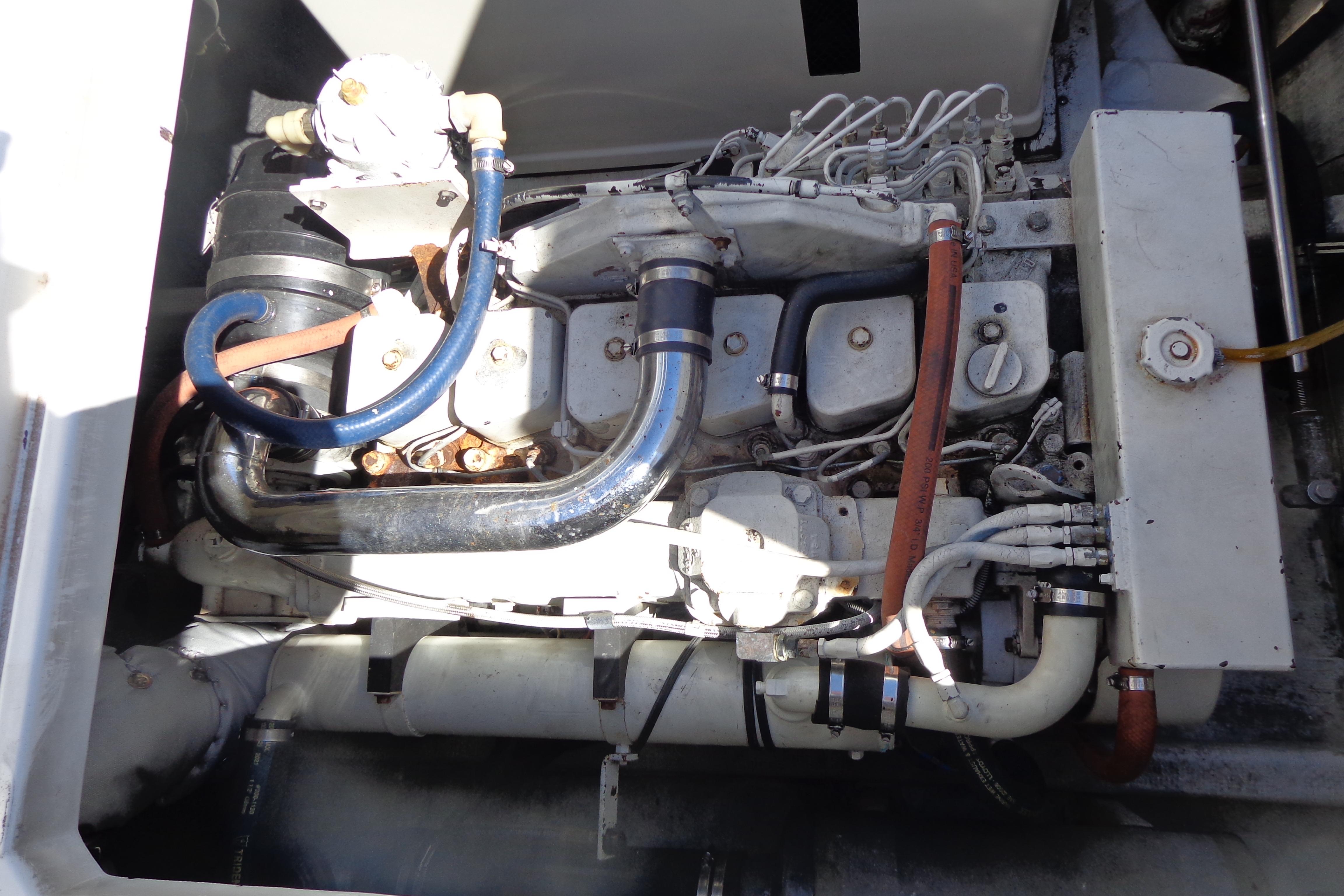 Engine compartment of a 1992 Cruise-A-Home Corsair 4200 boat, showcasing mechanical components.
