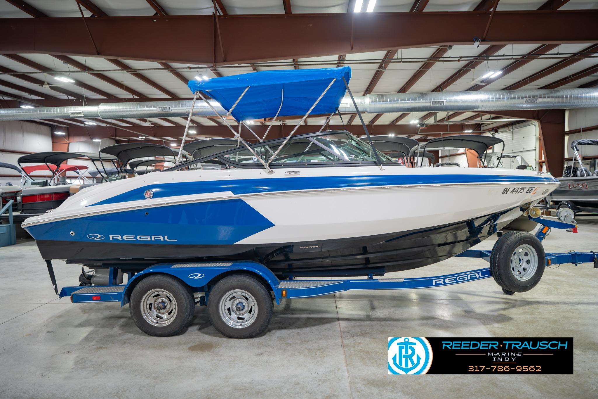 2015 Regal 2000 ESX Bowrider boat with blue accents on a trailer in a showroom.
