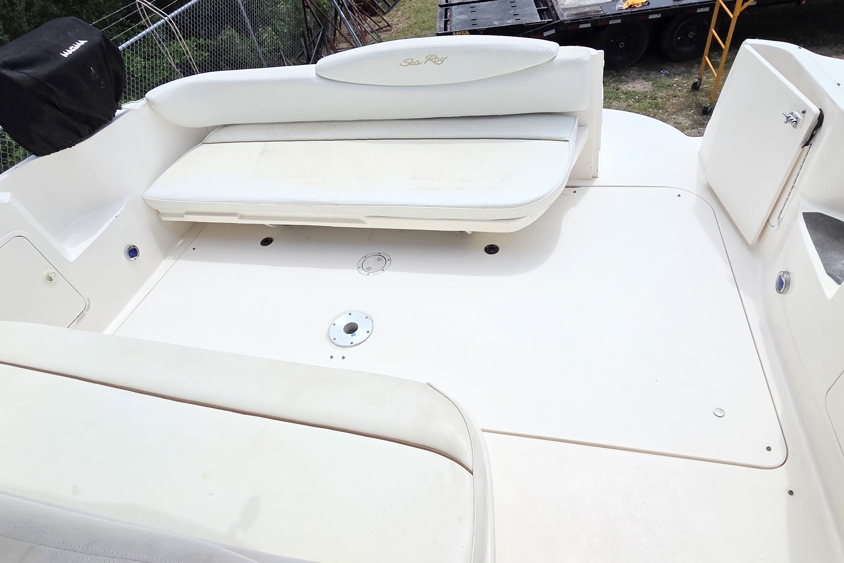 2000 Sea Ray 340 Sundancer boat deck with white seating and storage compartments.