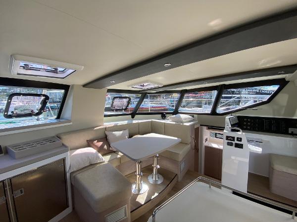 Vision 444 yacht interior, 2025 model, featuring modern seating, dining area, and panoramic windows.