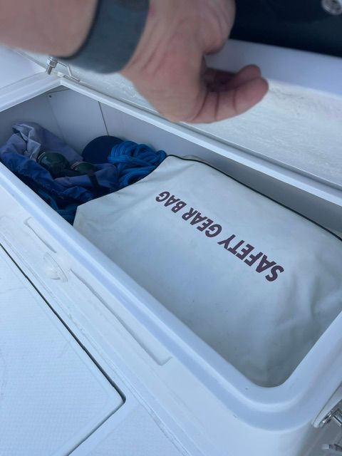 A safety gear bag in a storage compartment on a boat.
