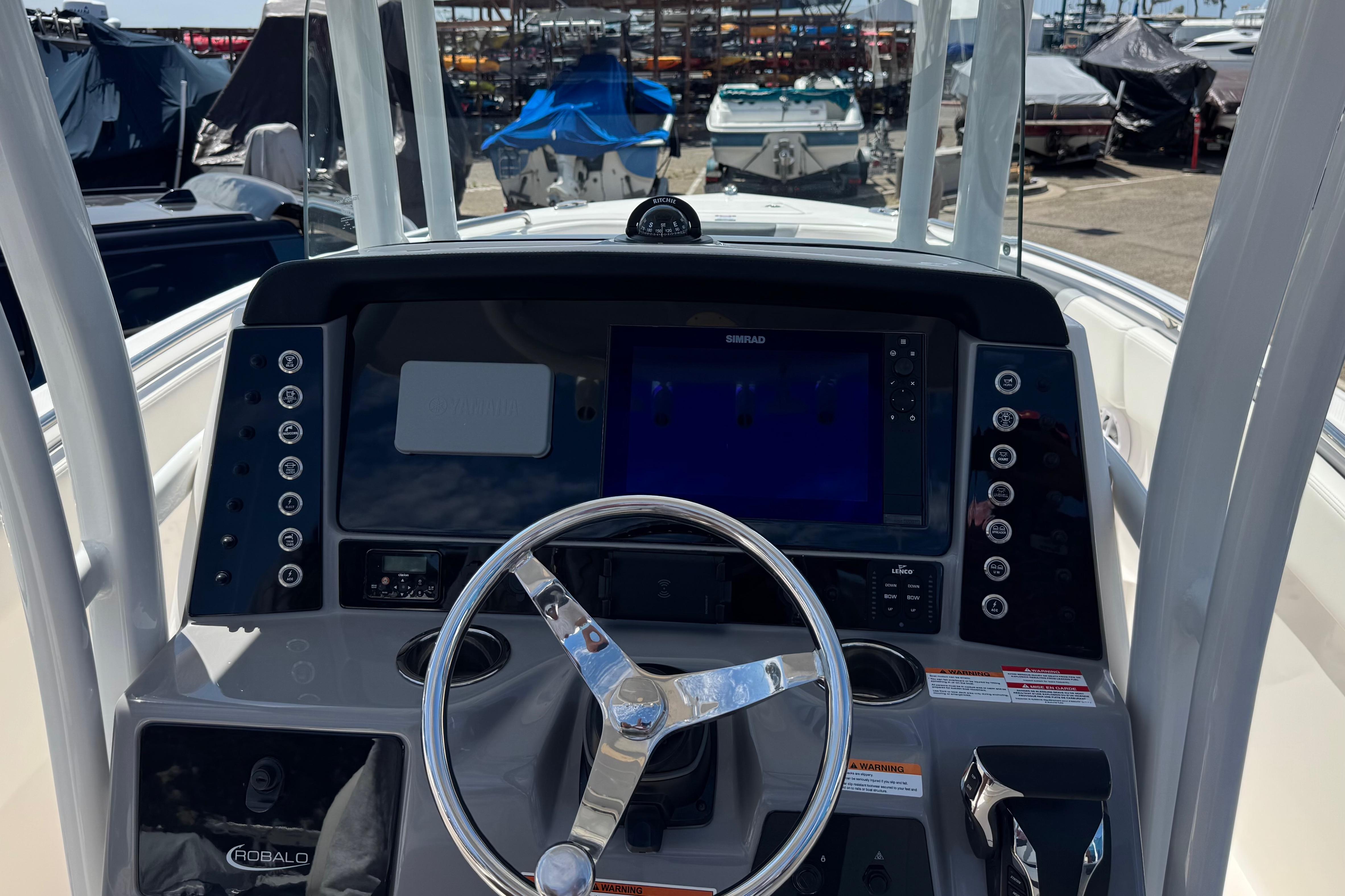 2022 Robalo R230 Center Console boat dashboard with steering wheel and navigation system.