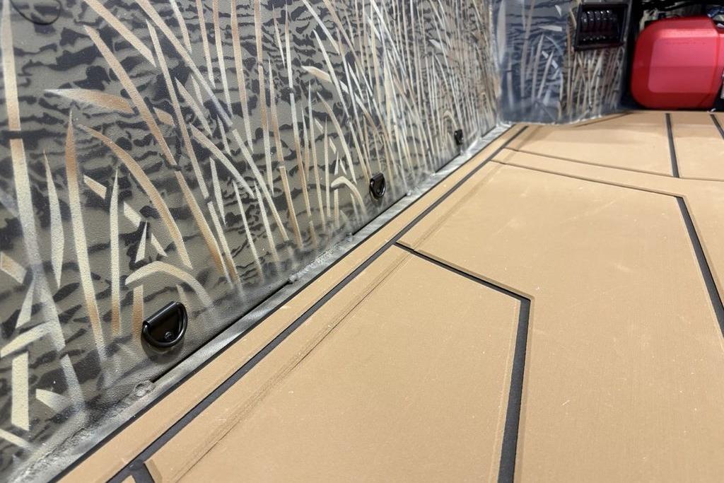2026 Tracker Grizzly 1650 T Prairie Wings Edition interior with camo design and tan flooring.
