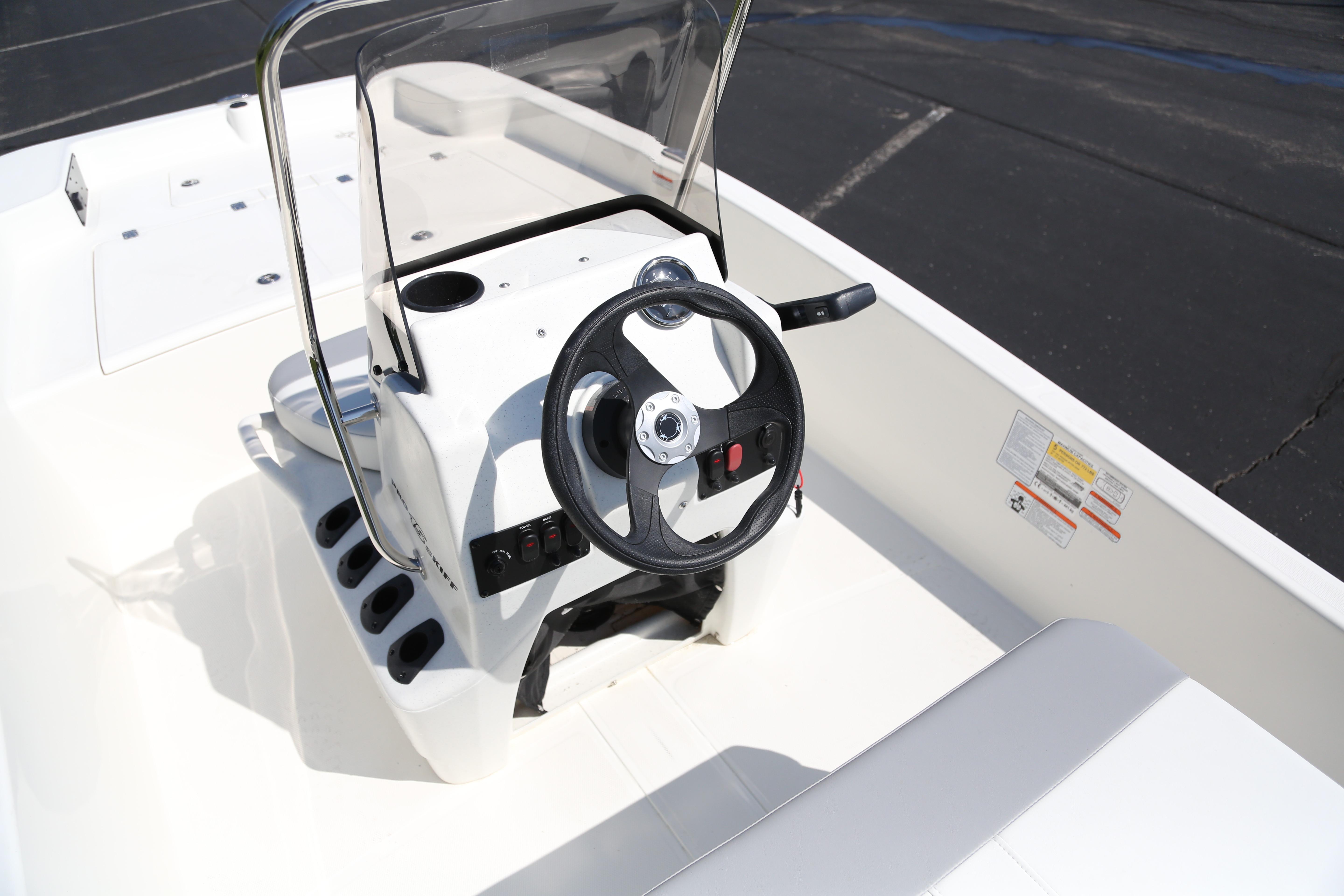 2026 Mako Pro Skiff 15 CC boat interior with steering wheel and console.