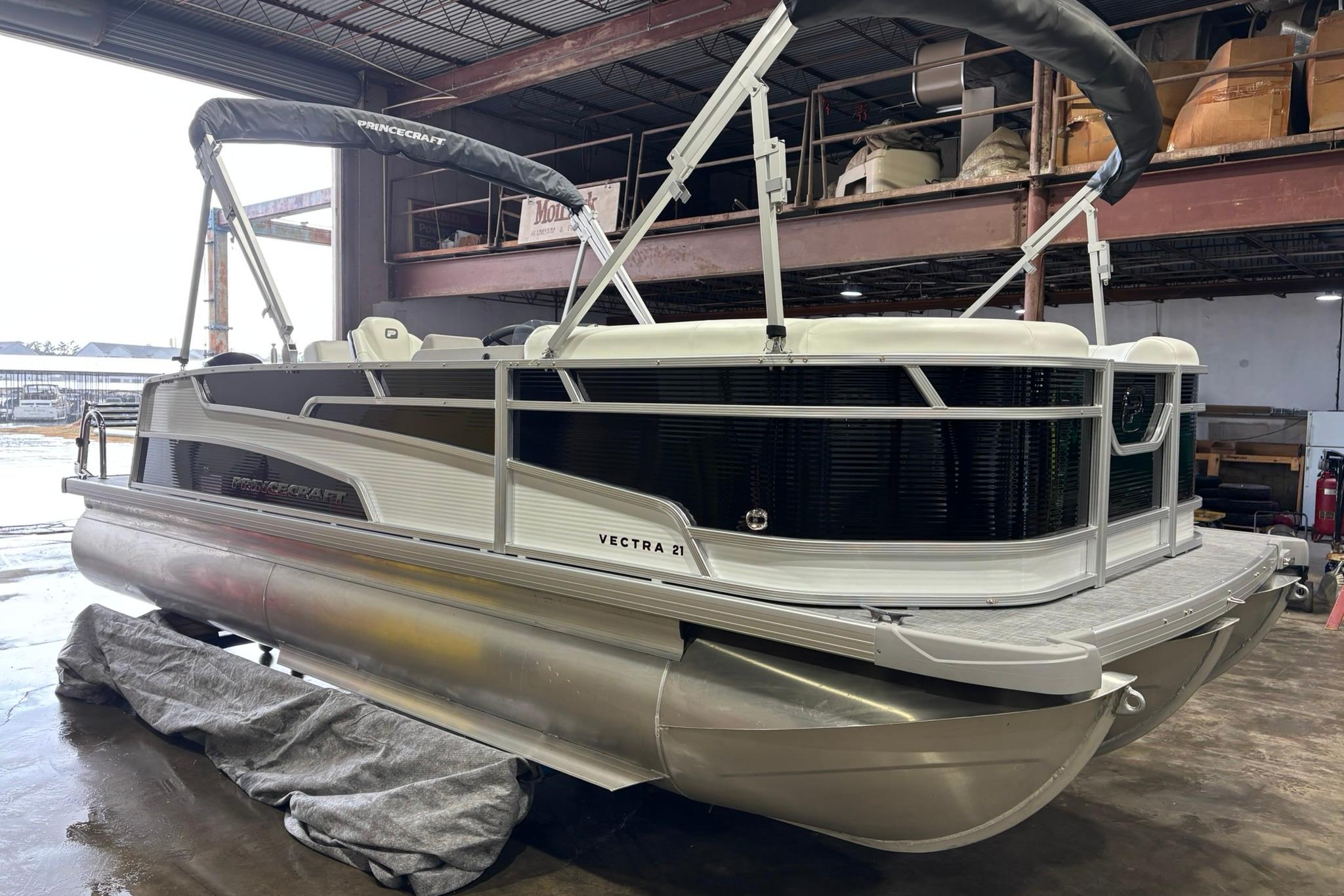 2025 Princecraft Vectra 21 RL pontoon boat in a warehouse setting.