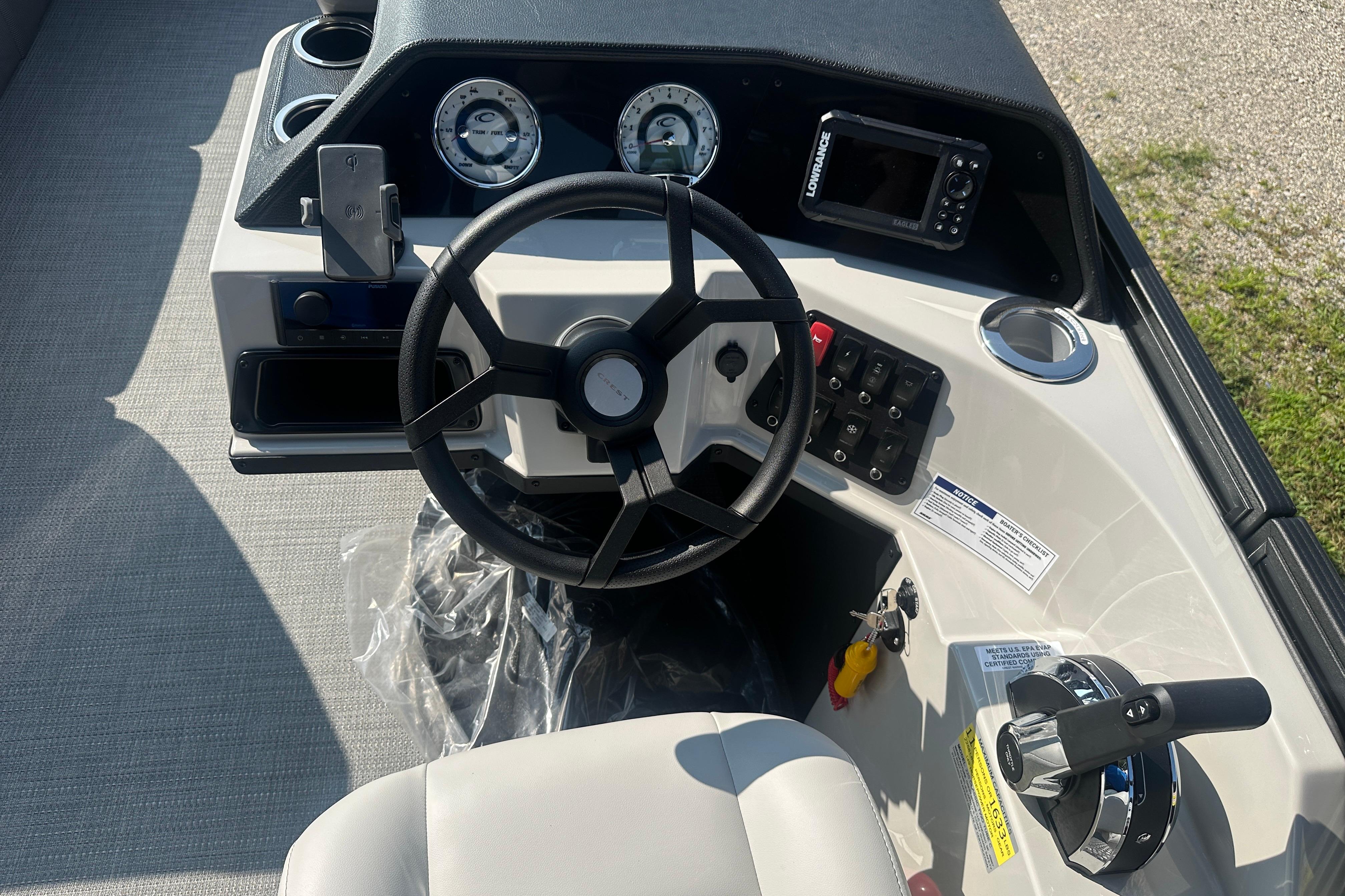 2025 Crest Classic 220 boat dashboard with steering wheel and control panel.