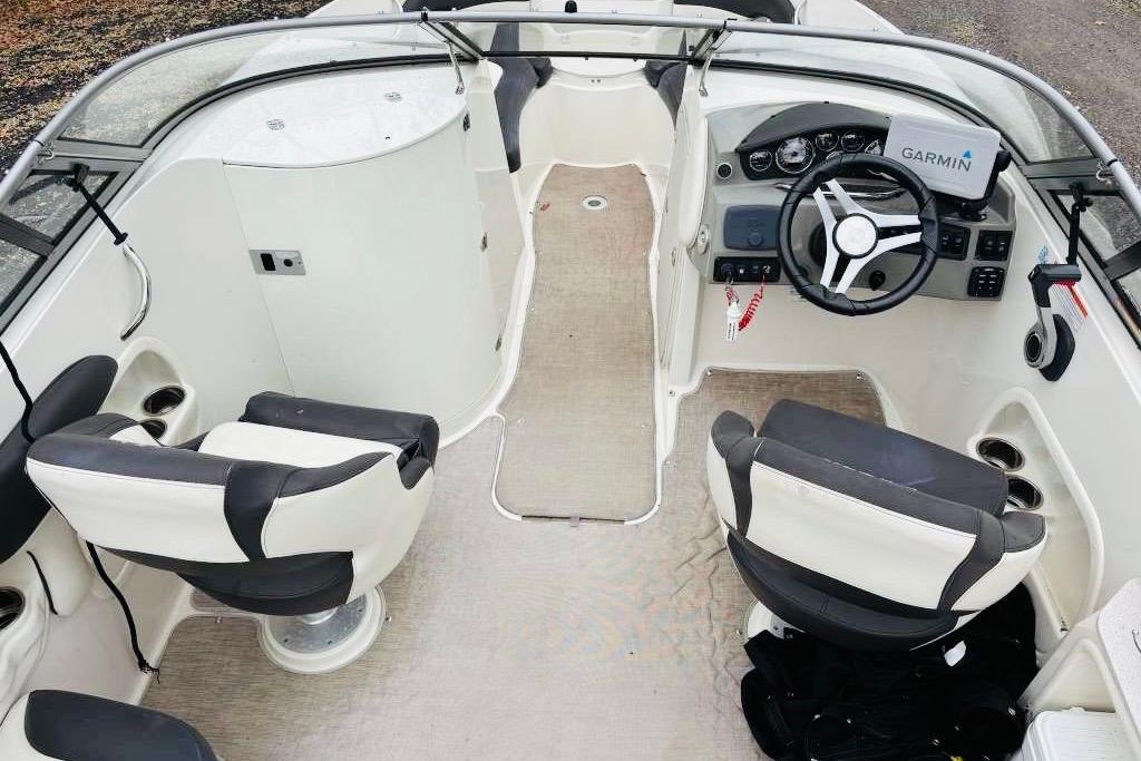 2018 Stingray 214 LR boat interior with steering wheel and seating.