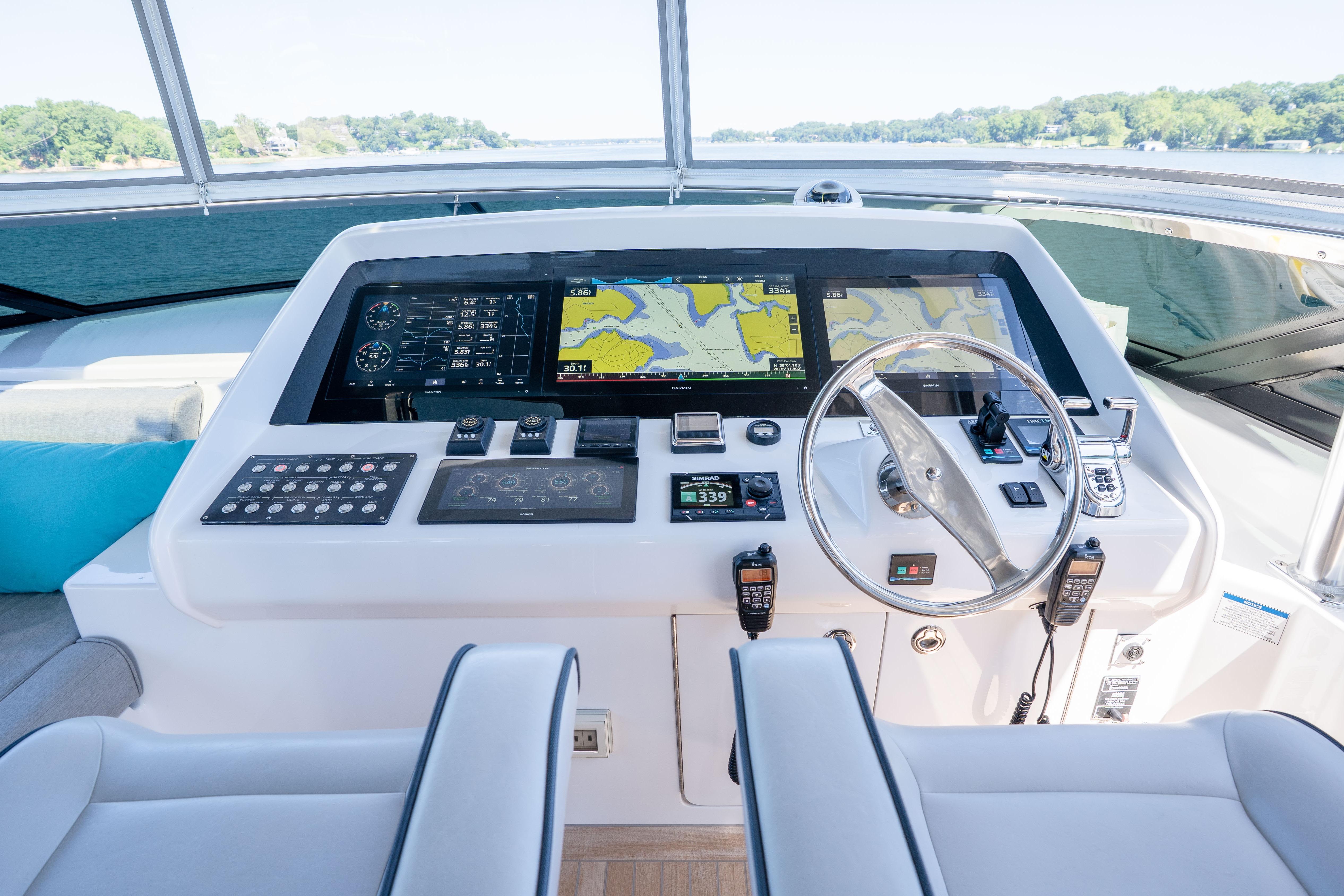 Helm of 2021 Hatteras M75 Panacera yacht with advanced navigation systems and dual displays.