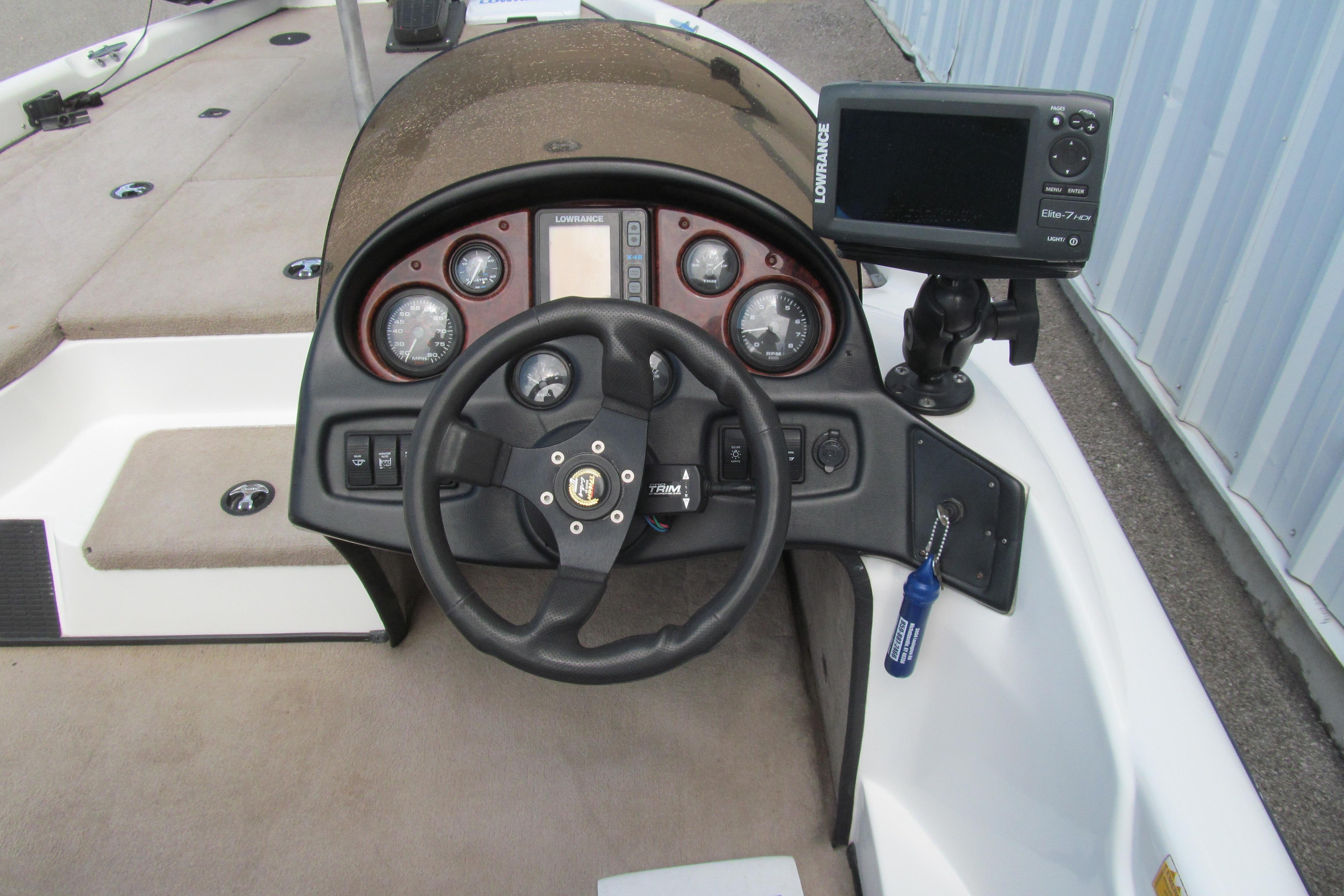 2002 Triton Tr-176 SC boat dashboard with steering wheel and Lowrance fishfinder.