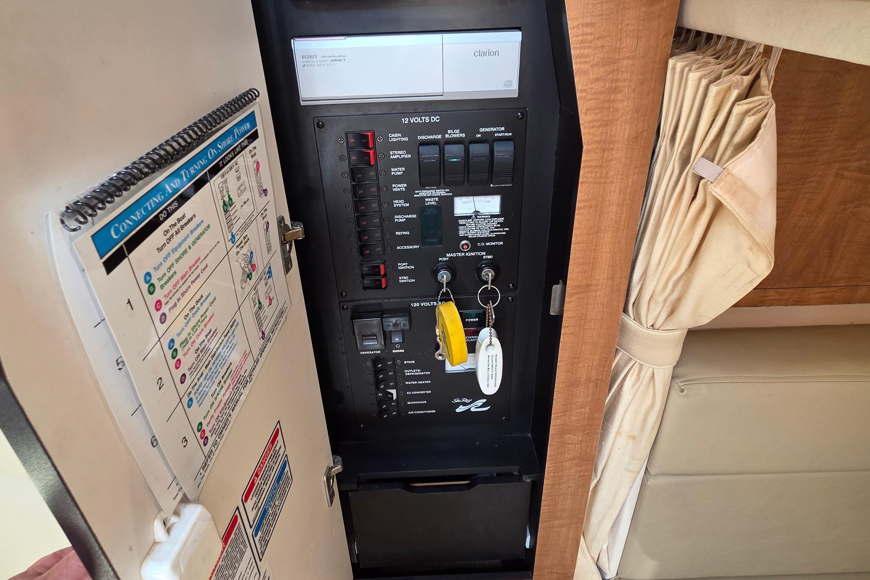 Electrical panel inside 2006 Sea Ray Sundancer 320 boat, featuring switches and keys.