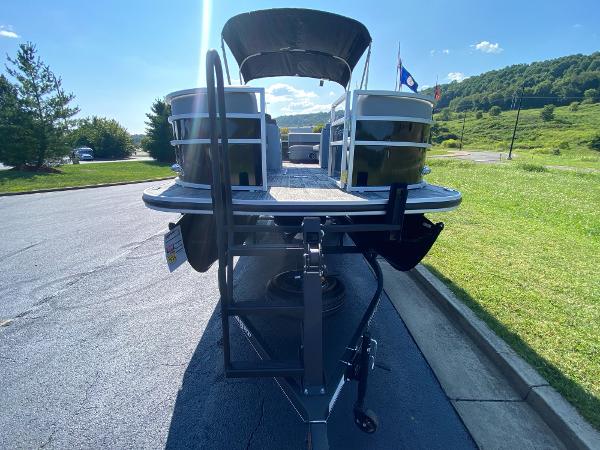 2024 Ranger Reata 223C pontoon boat on trailer, sunny day, scenic background.