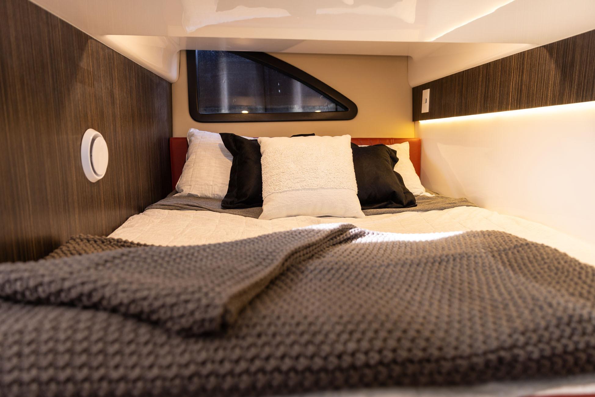 Cozy interior of 2026 Hanover 387 with plush bedding and modern design.