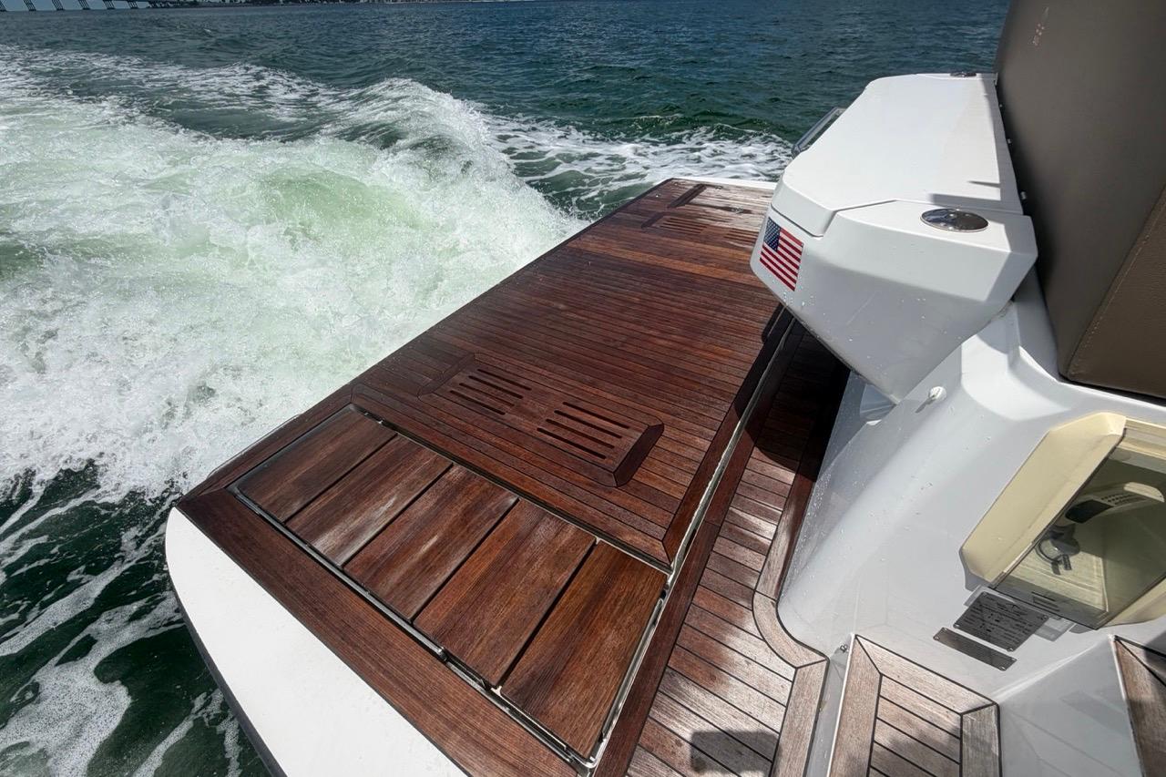 2022 Sealine C430 yacht with teak deck cruising on open water.