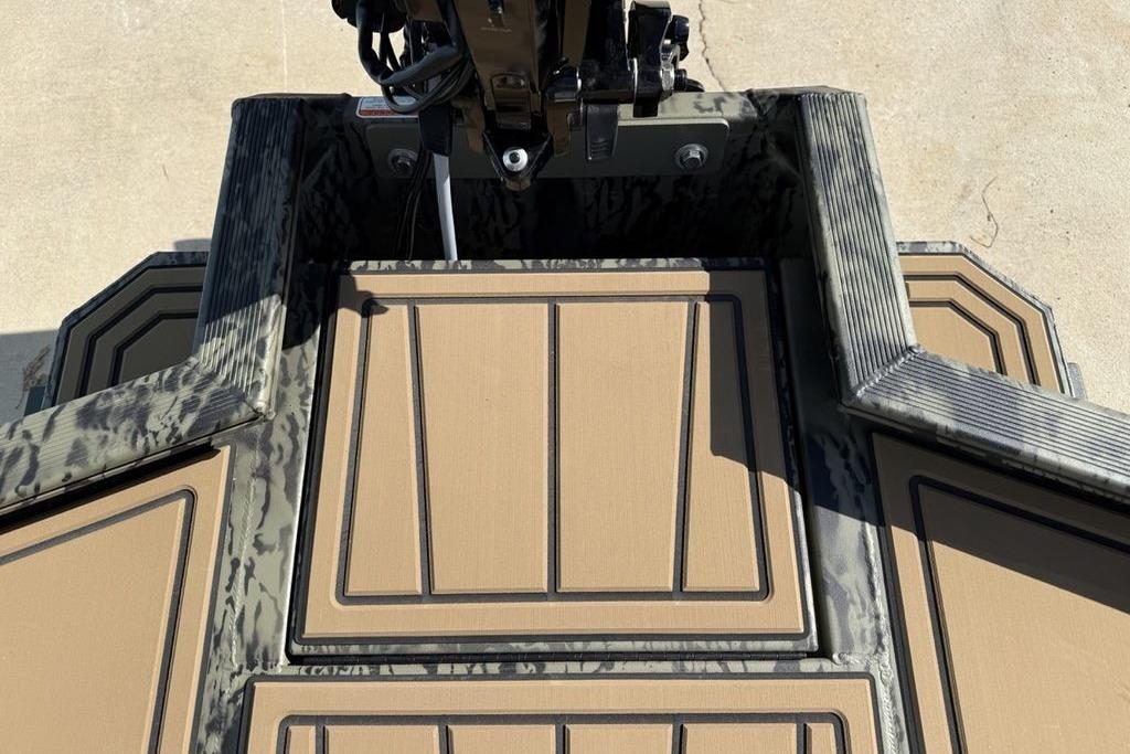 Tracker Grizzly 1650 T Prairie Wings Edition 2026 boat deck with camouflage design.