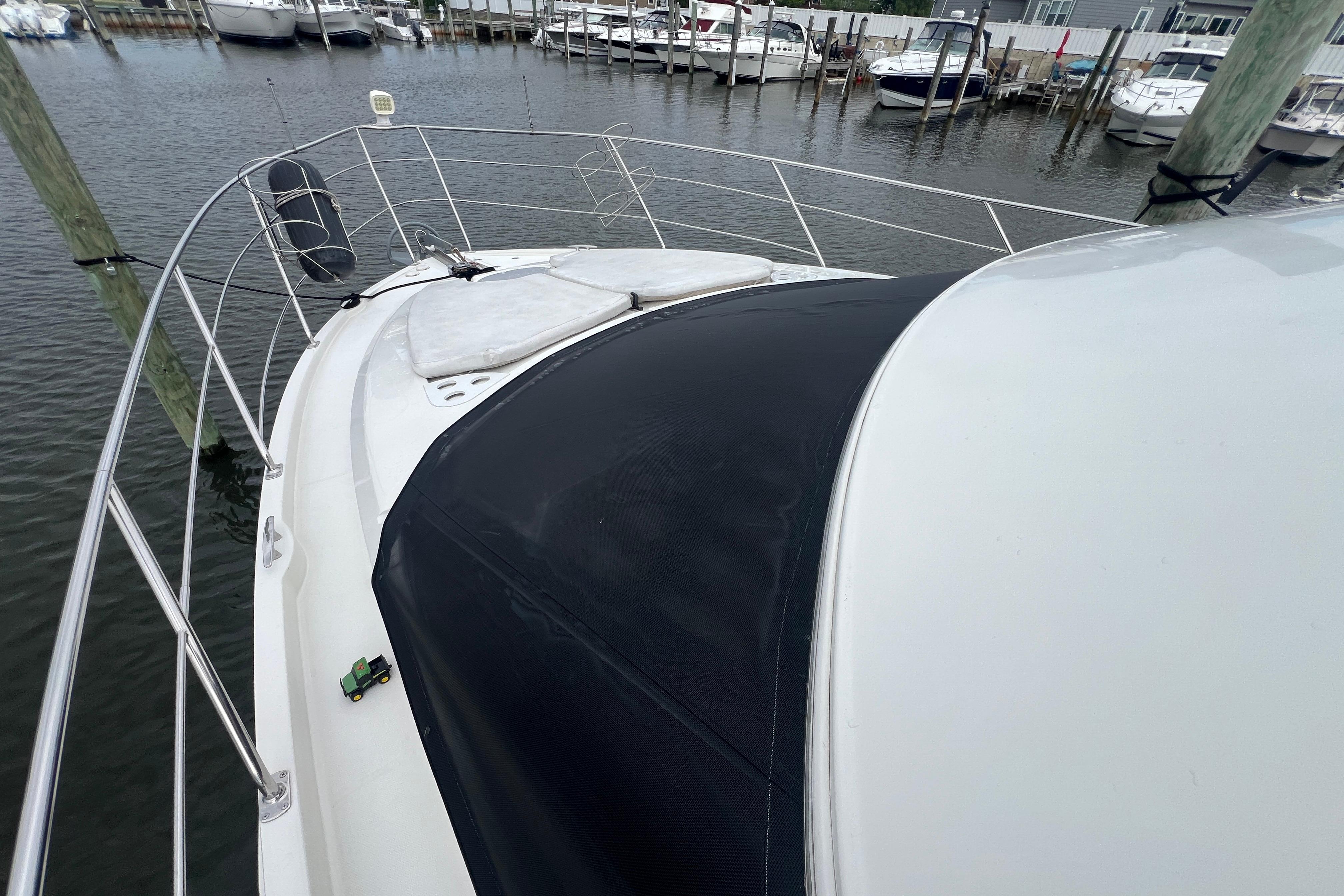 2006 Carver 43 Motor Yacht docked at marina, showcasing bow and railing.