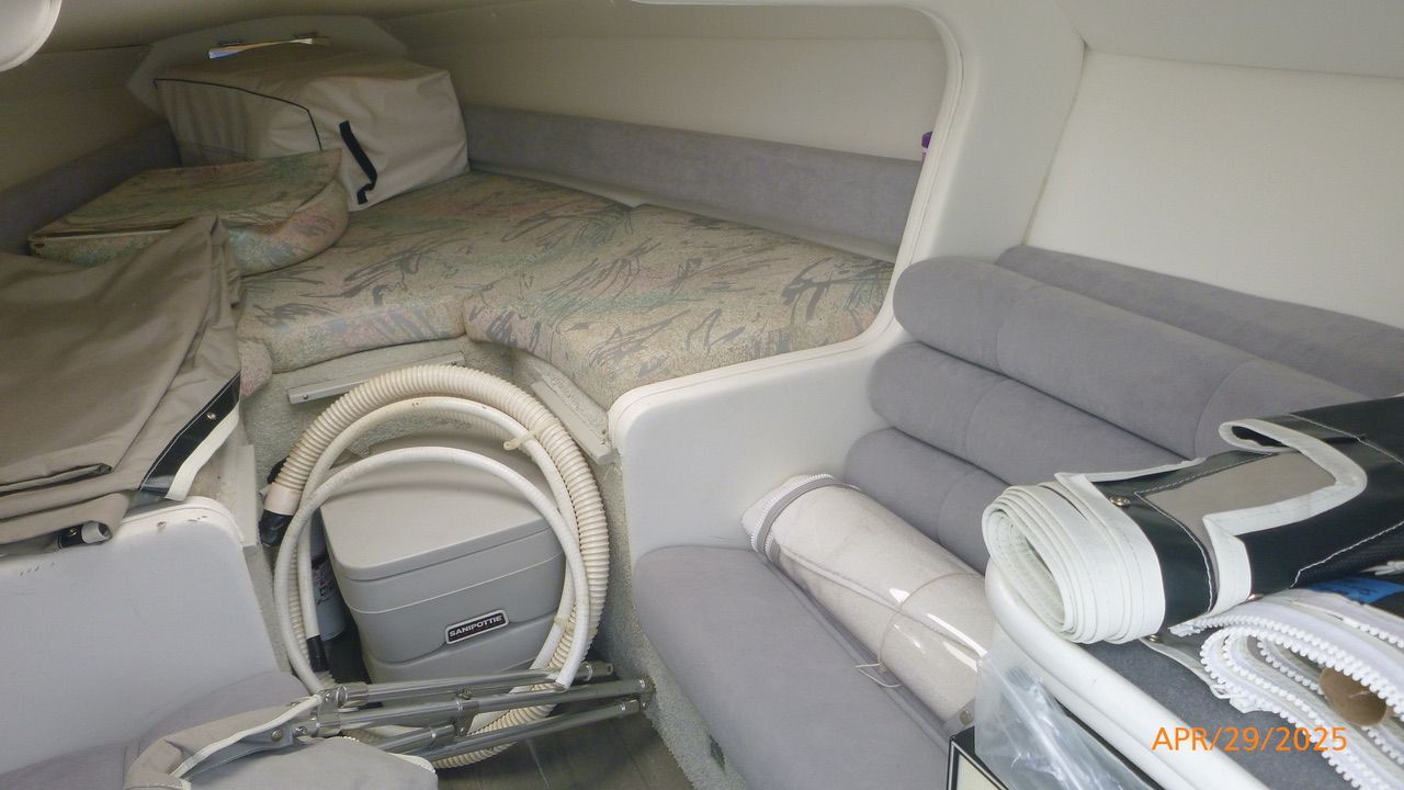 Interior of a 1992 Powerquest 270 Laser with seating and storage space.