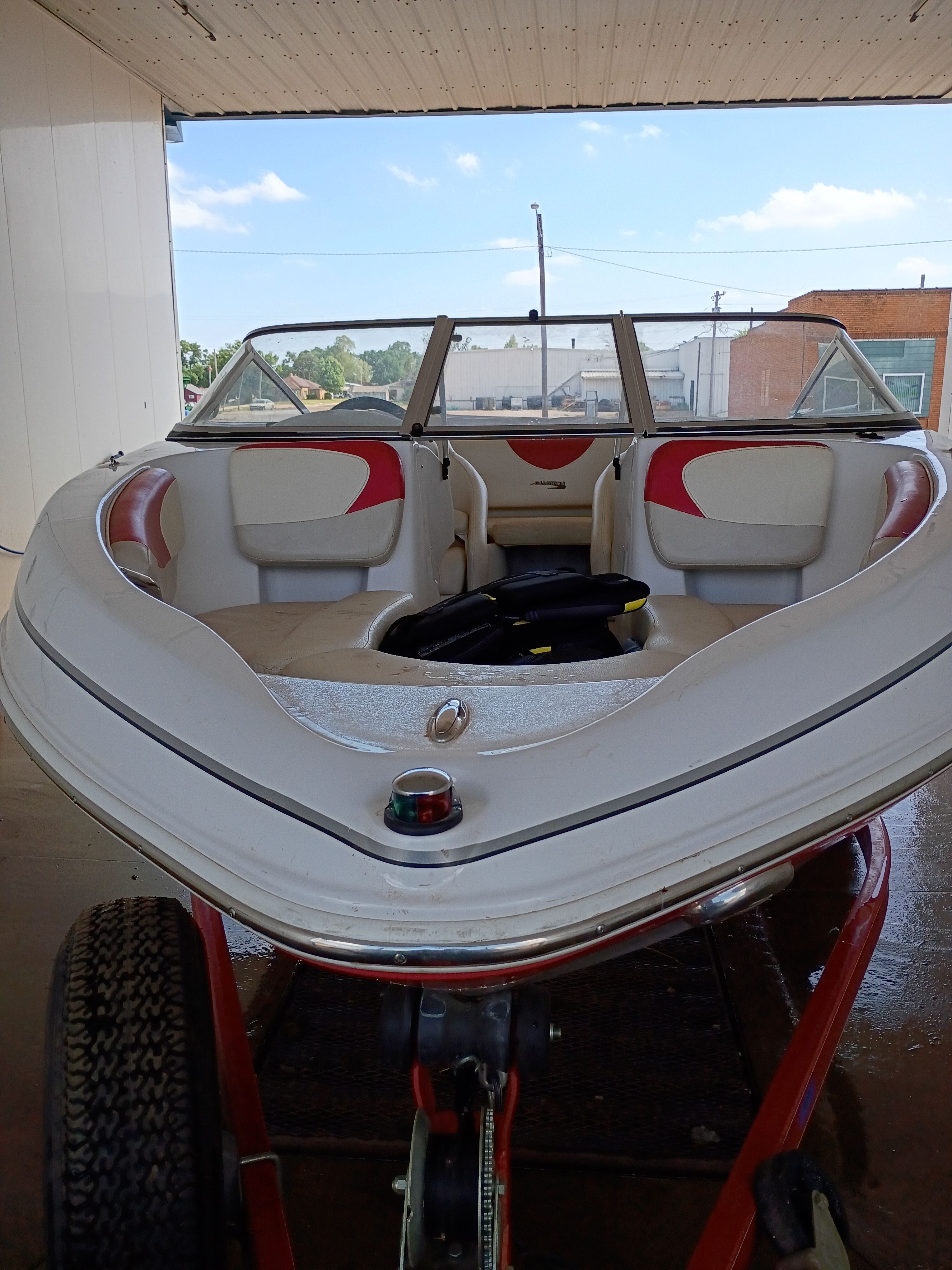 2010 Glastron MX 185 boat on trailer in garage.