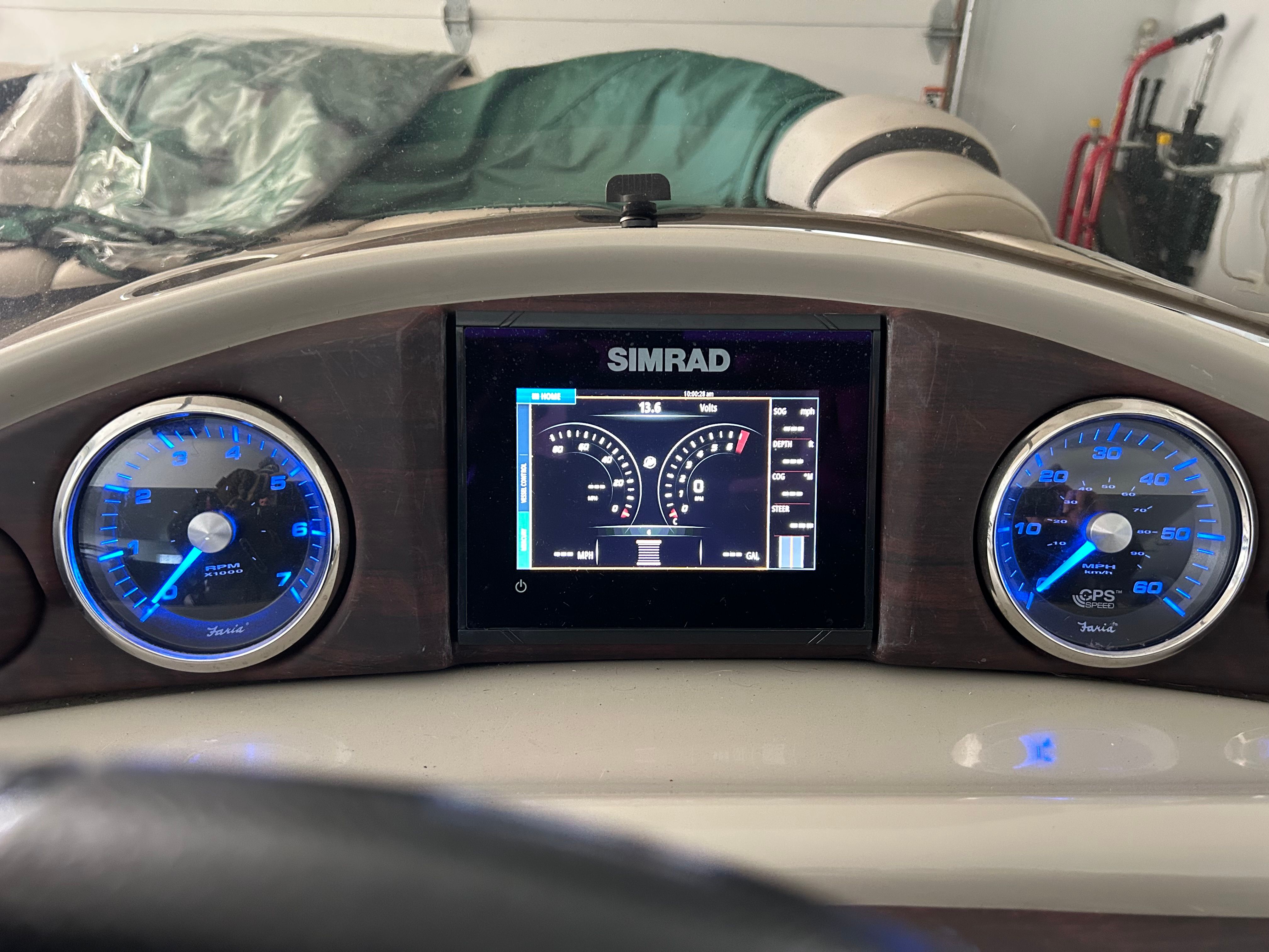 Dashboard of a boat with digital displays and blue dials.