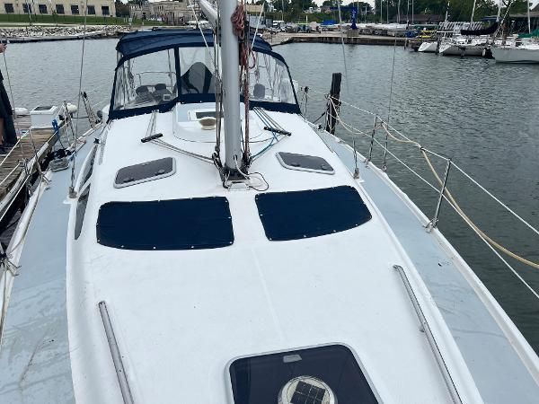The image shows a 2000 Hunter 410 sailboat docked at a marina.