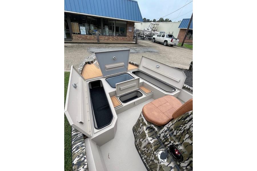 2026 Avid 21 FSX boat interior with open storage compartments and camo seating.