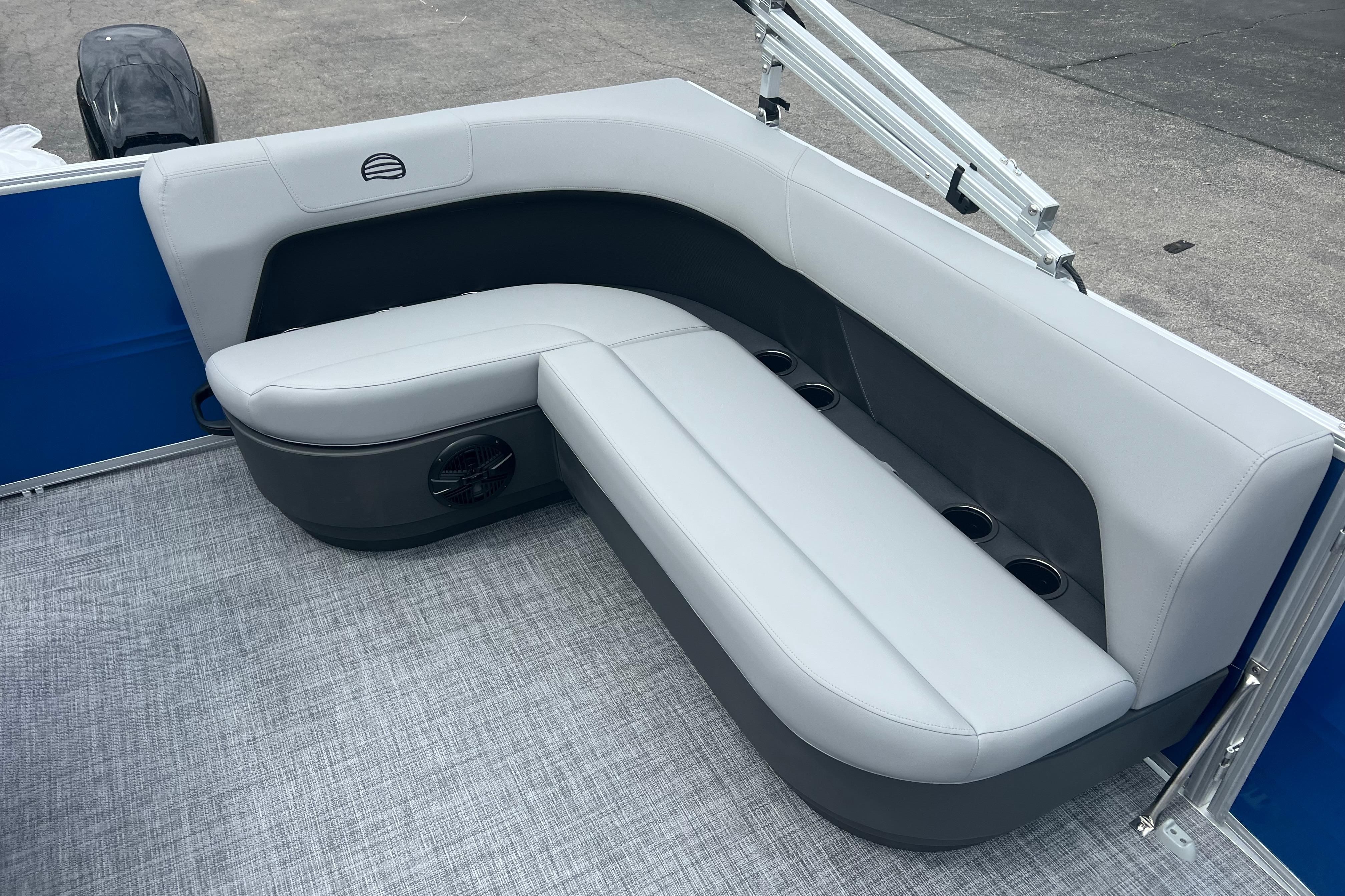 2026 Sun Tracker Party Barge 16 DLX interior seating with cup holders and speaker.