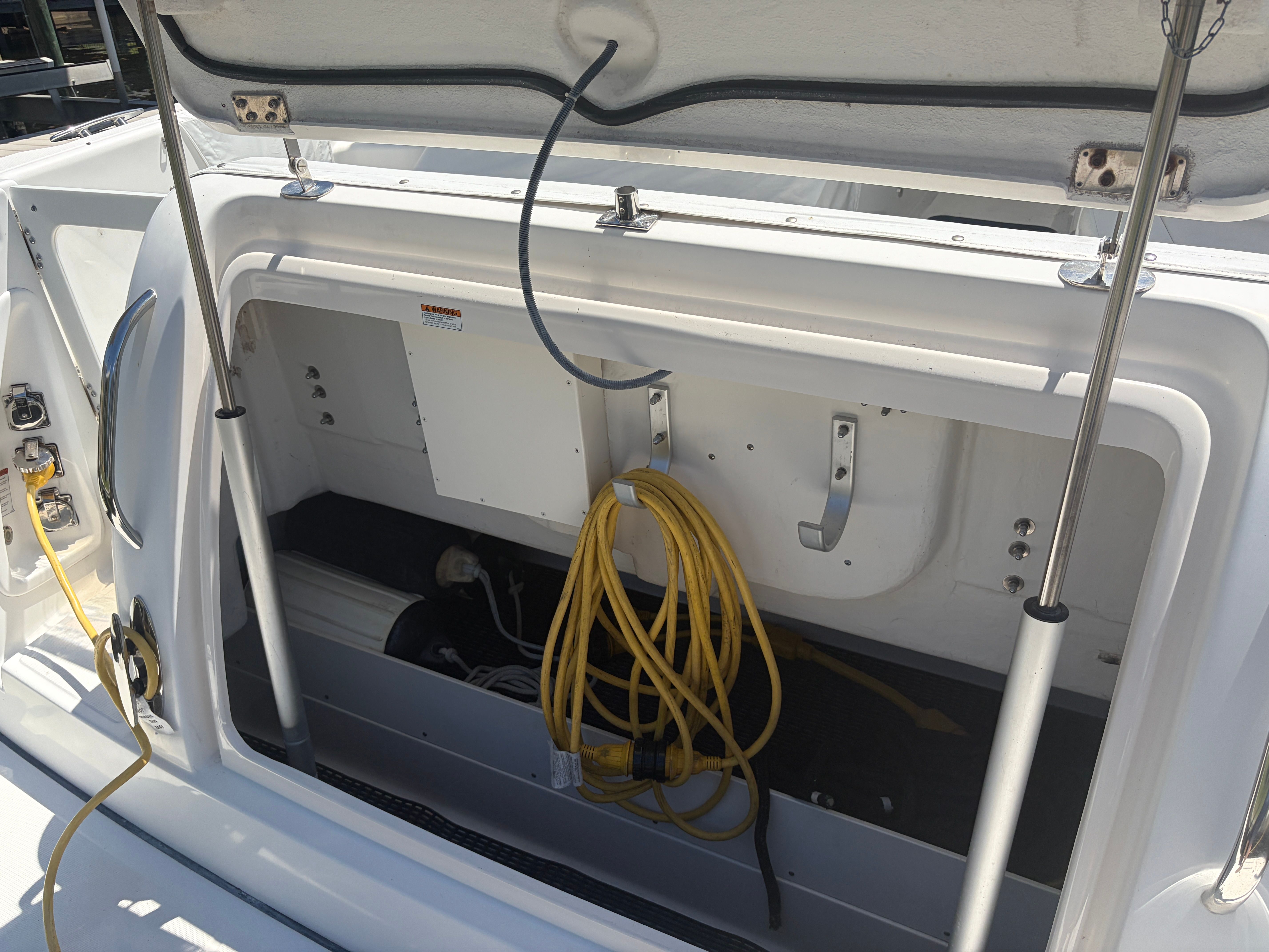 2005 Tiara Yachts Sovran storage compartment with cables and connections.