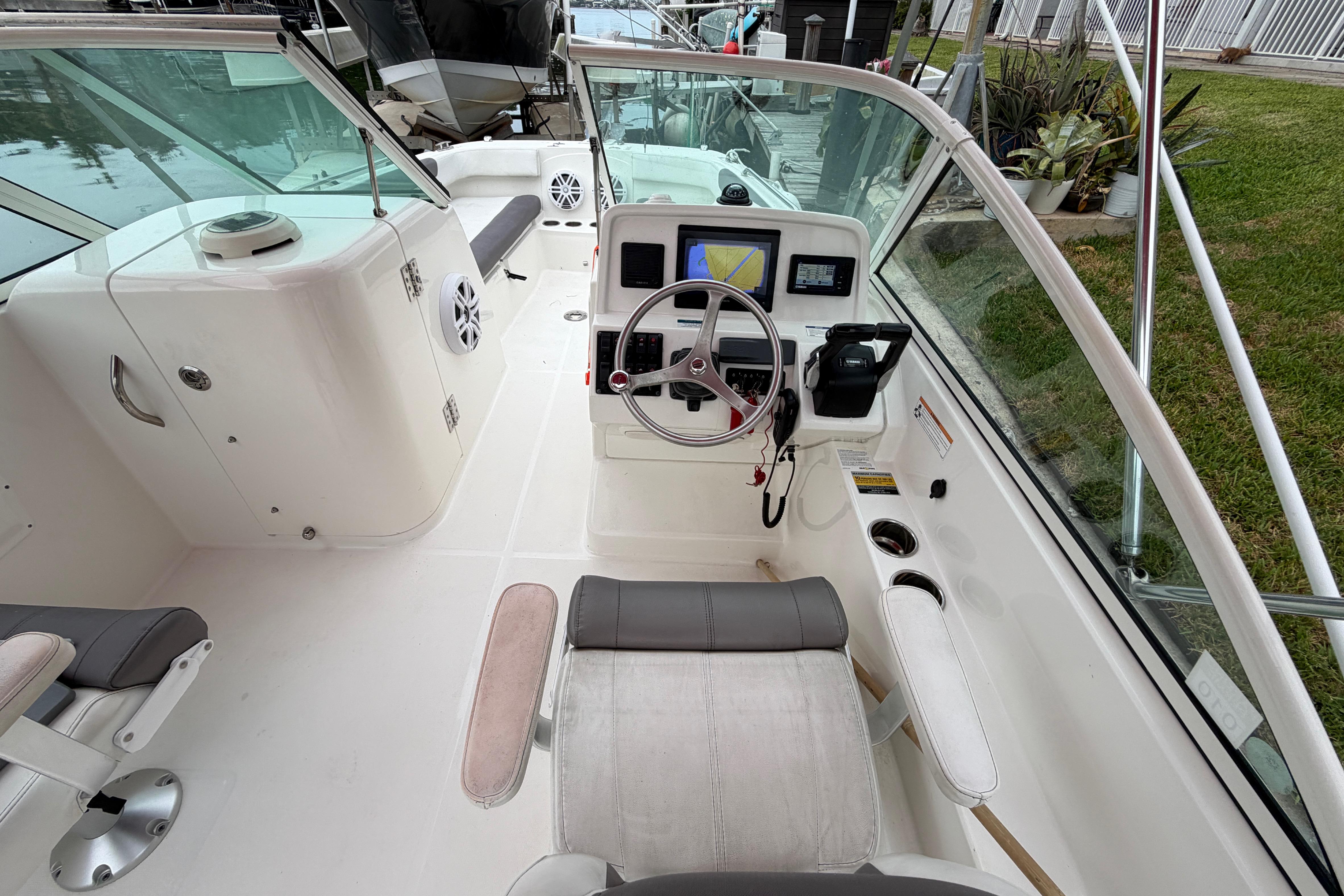 2019 World Cat 230 DC boat interior with steering wheel and navigation system.