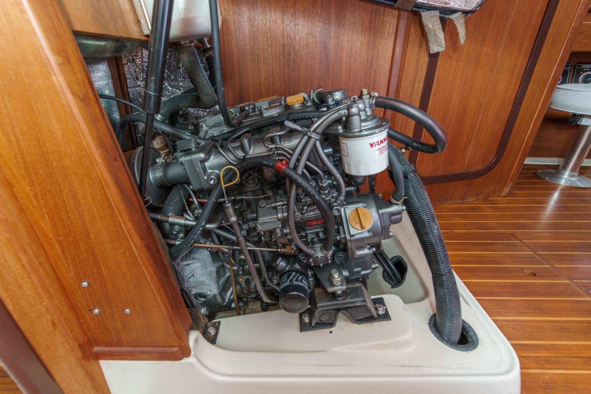 Engine compartment of a 1996 Hunter 376 sailboat, featuring a Yanmar engine.