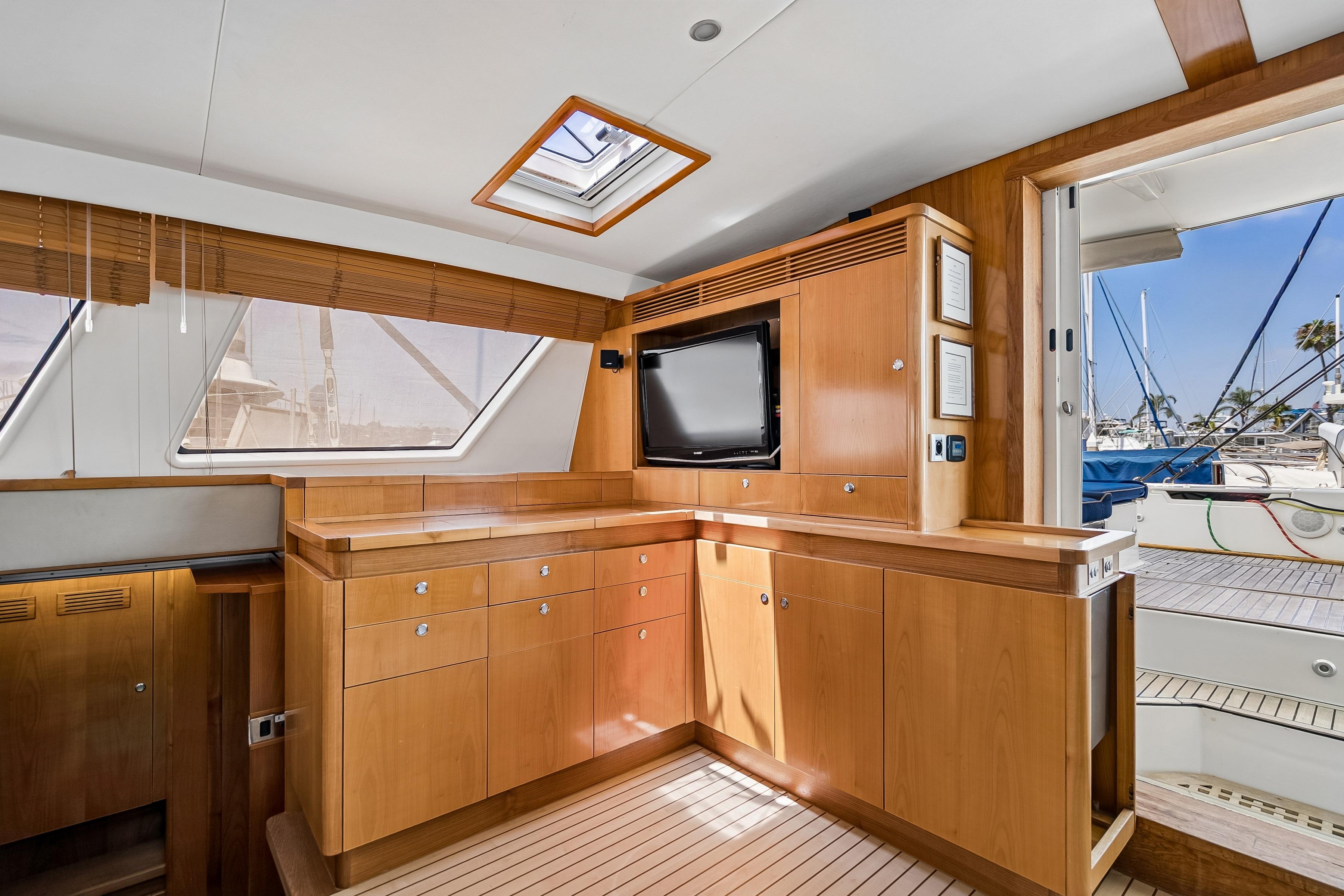 Luxurious interior of 2009 Catana 65 yacht with wooden cabinetry and modern amenities.
