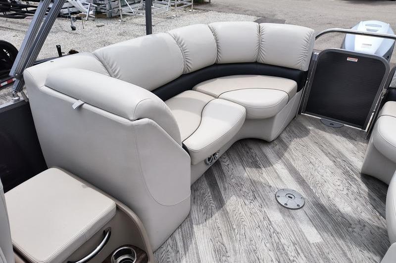 2017 Manitou 25 Oasis SE pontoon boat interior with plush seating and wood-style flooring.