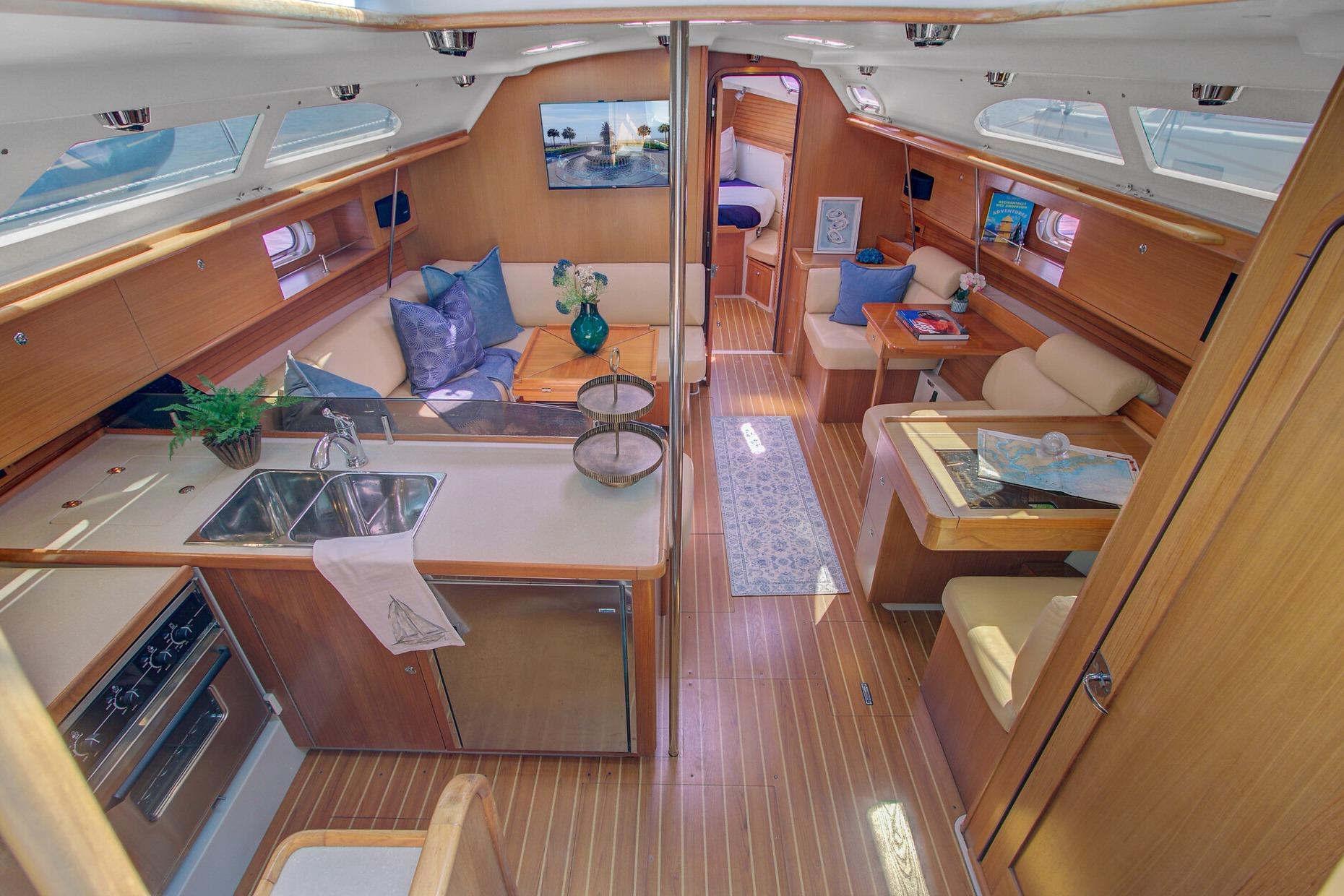 Luxurious interior of a 2011 Catalina 445 yacht, featuring a spacious kitchen and seating area.