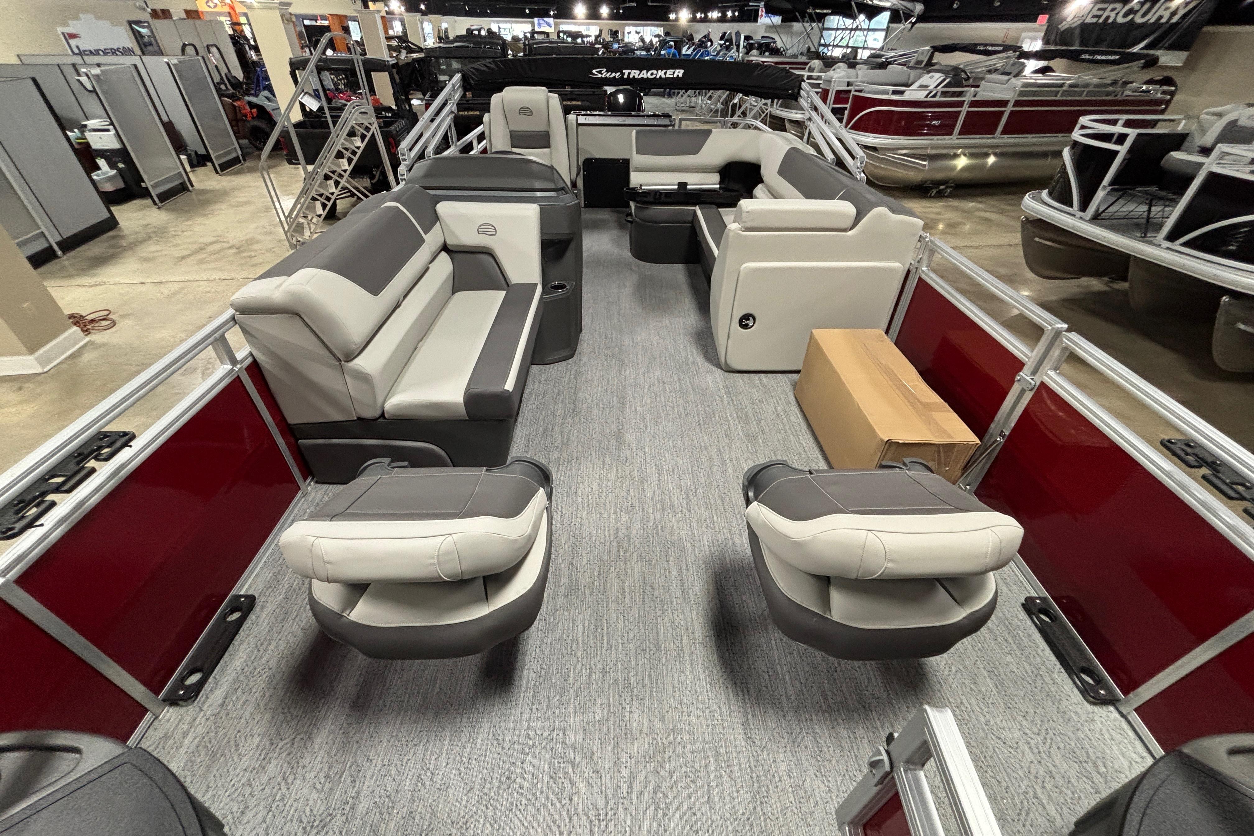 2026 Sun Tracker Fishin' Barge 22 DLX interior with seating and storage.