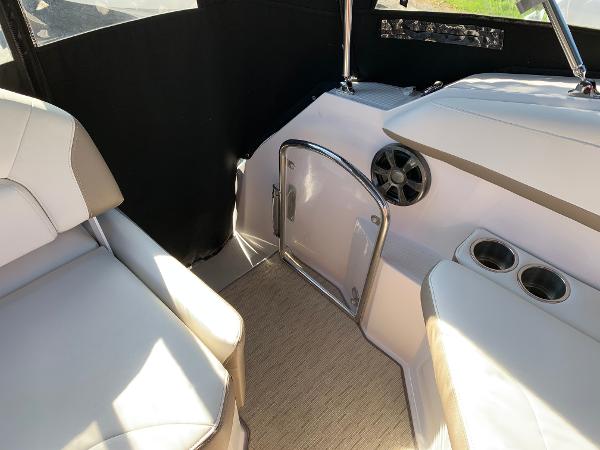 Interior of a 2017 Regal 26 Express with beige seating and a speaker.