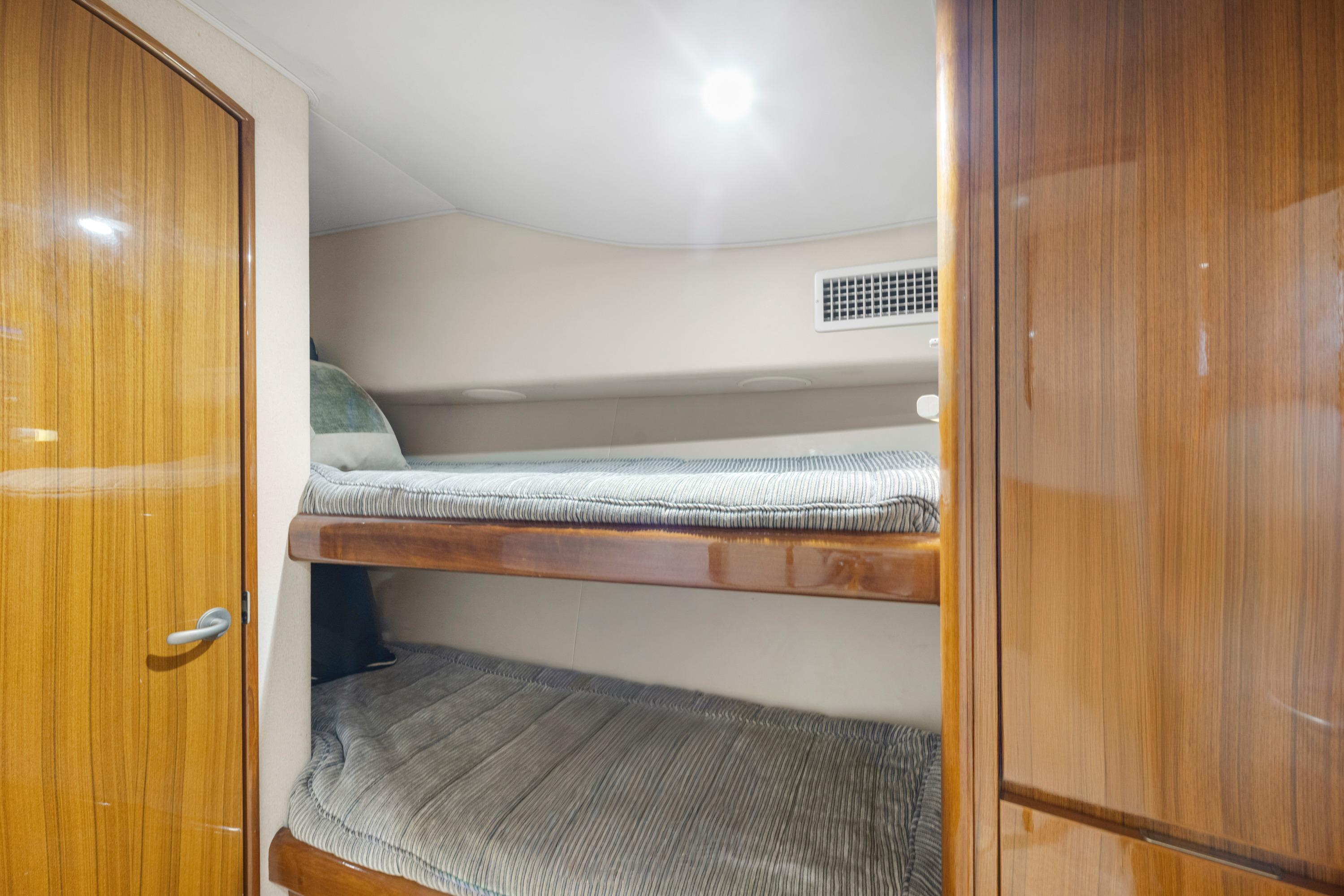 2009 Viking 50 Convertible yacht interior with wooden bunk beds and modern design.