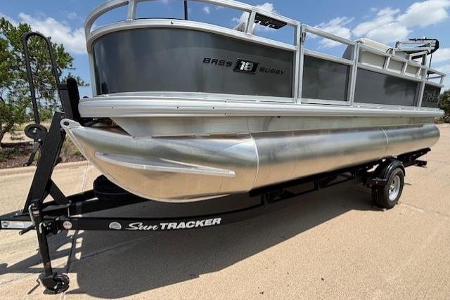 2026 Sun Tracker Bass Buggy 18 DLX pontoon boat on trailer, side view.