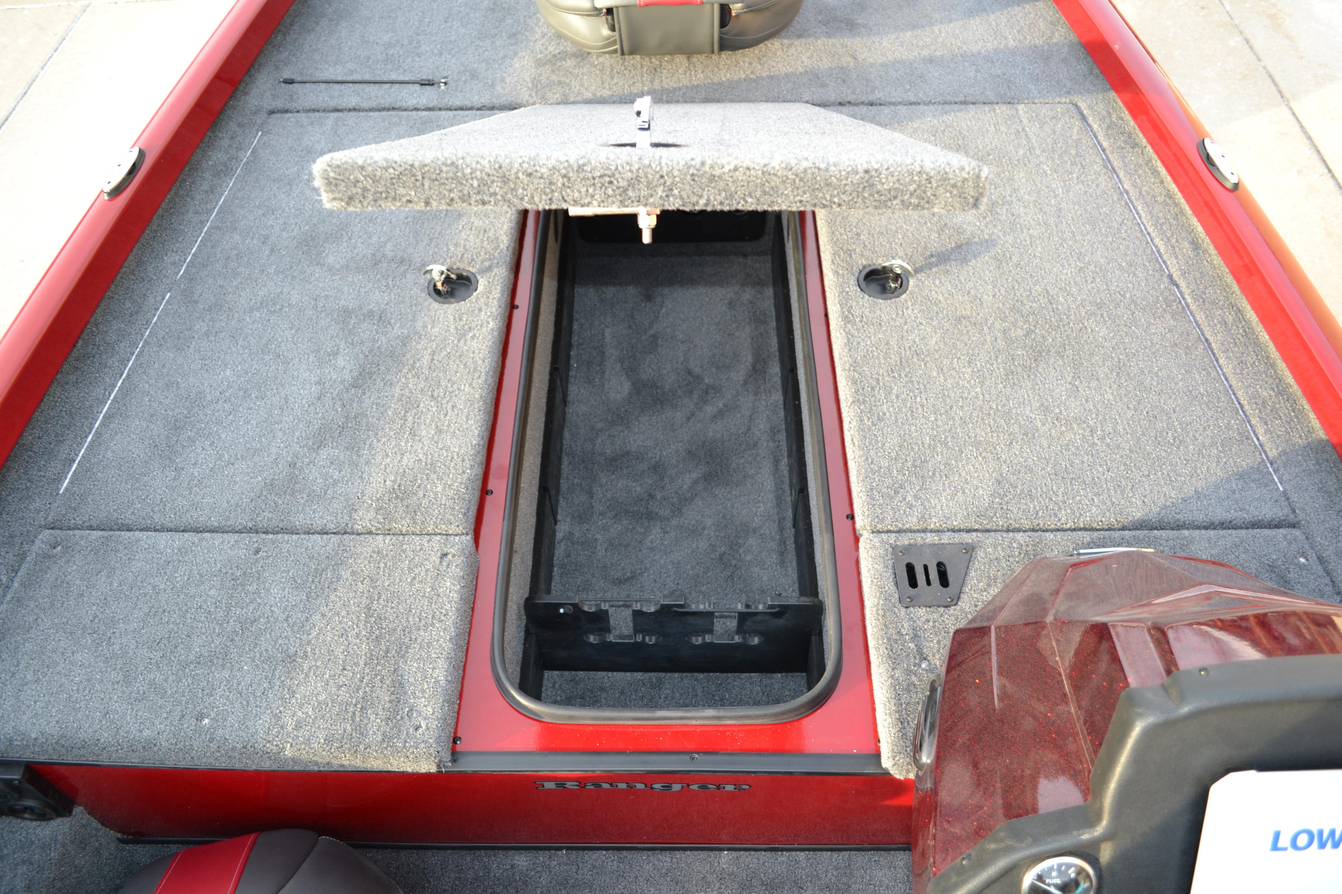 2026 Ranger RT188 boat interior with open storage compartment, featuring gray carpeting and red trim.