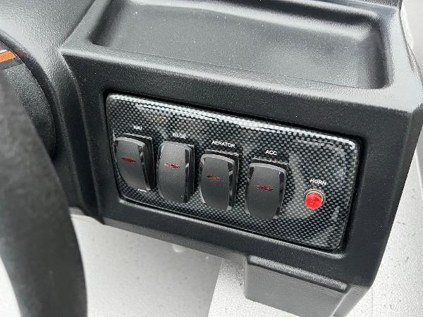 2024 Lowe Legacy boat dashboard with control switches and horn button.