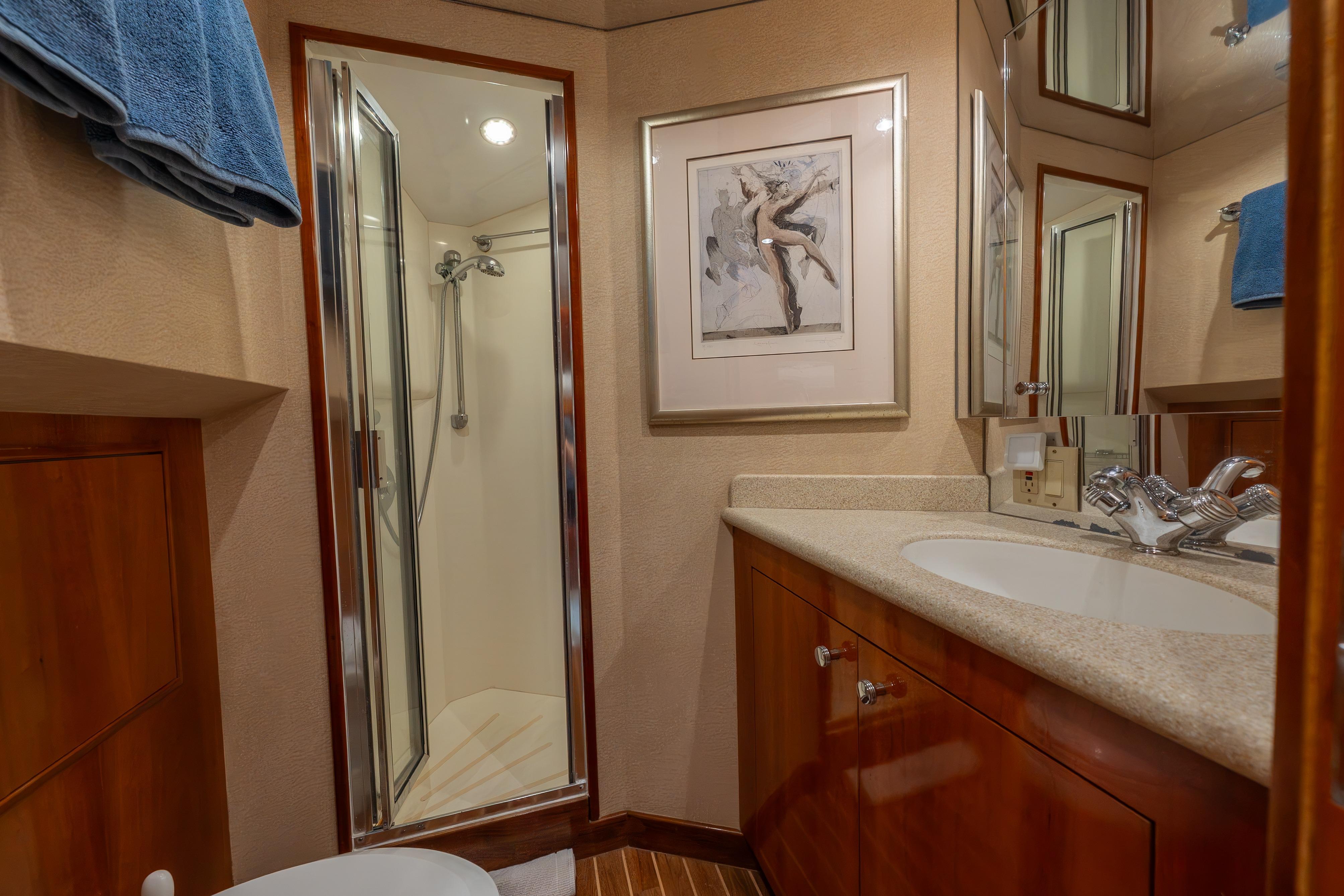 Luxurious bathroom on 2004 Hatteras 75 Sport Deck Motor Yacht with shower and elegant fixtures.