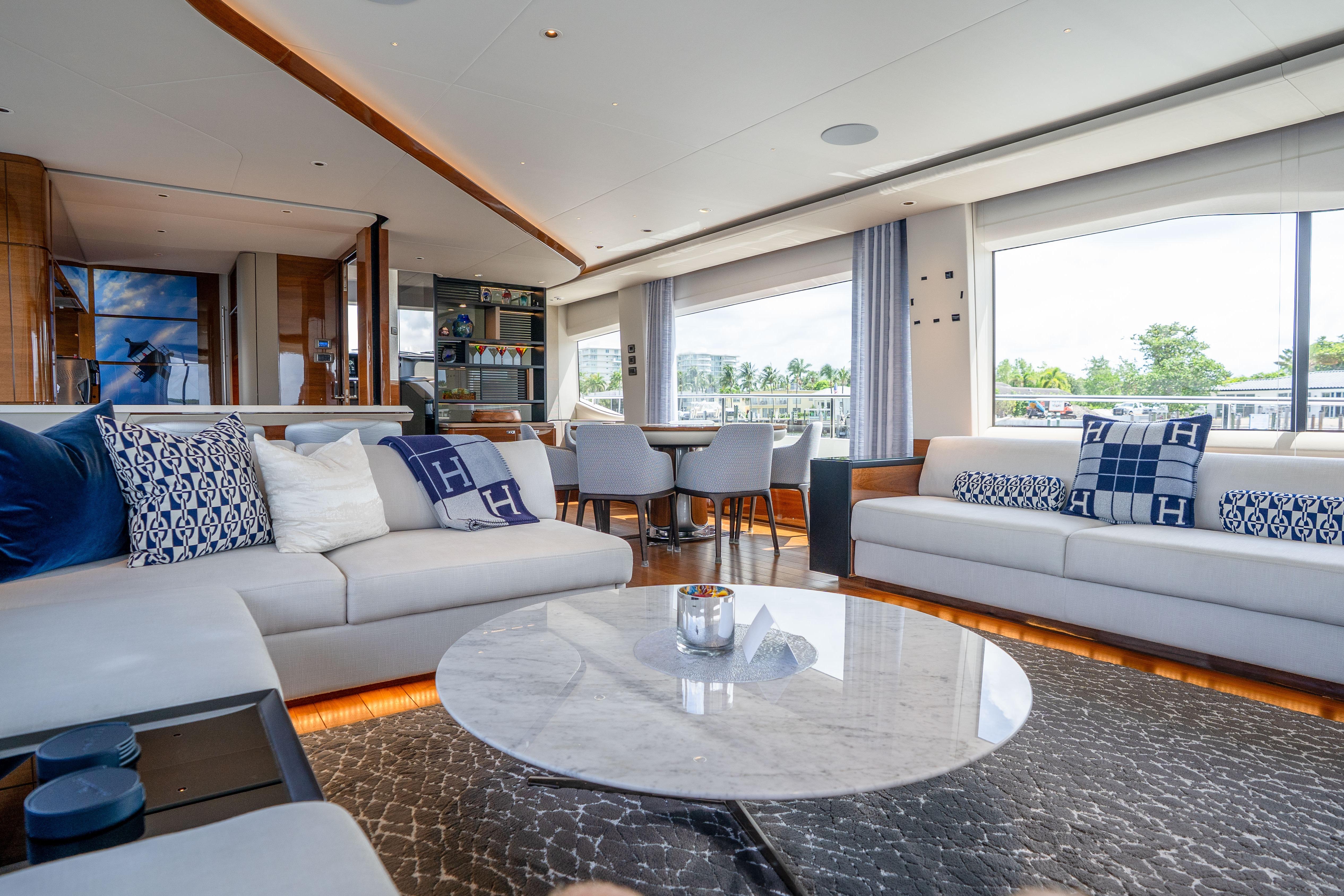 Luxurious interior of 2020 Princess Y85 yacht with elegant seating and large windows.