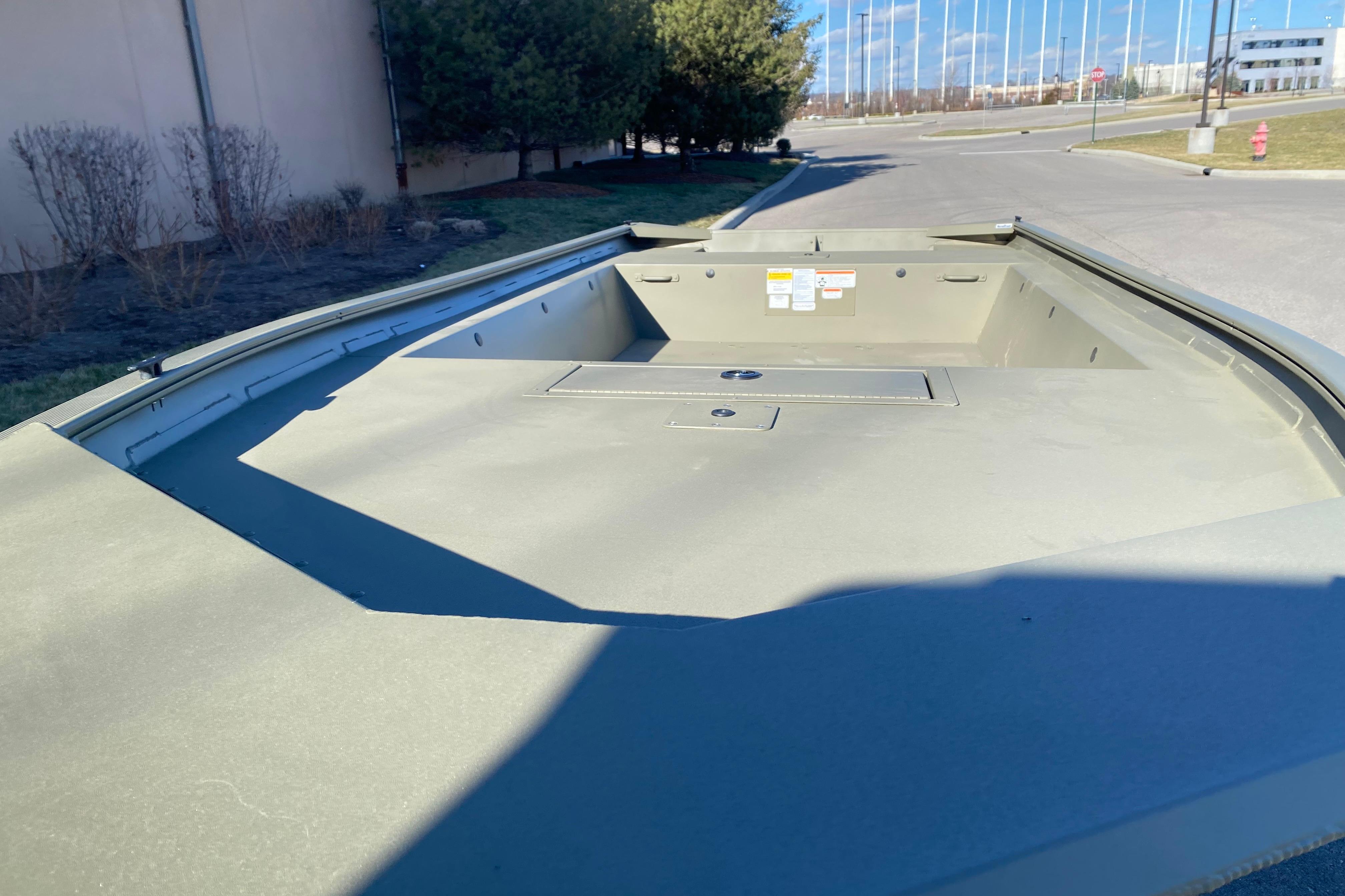 2026 Tracker Grizzly 1754 Utility boat, empty deck view, outdoors.
