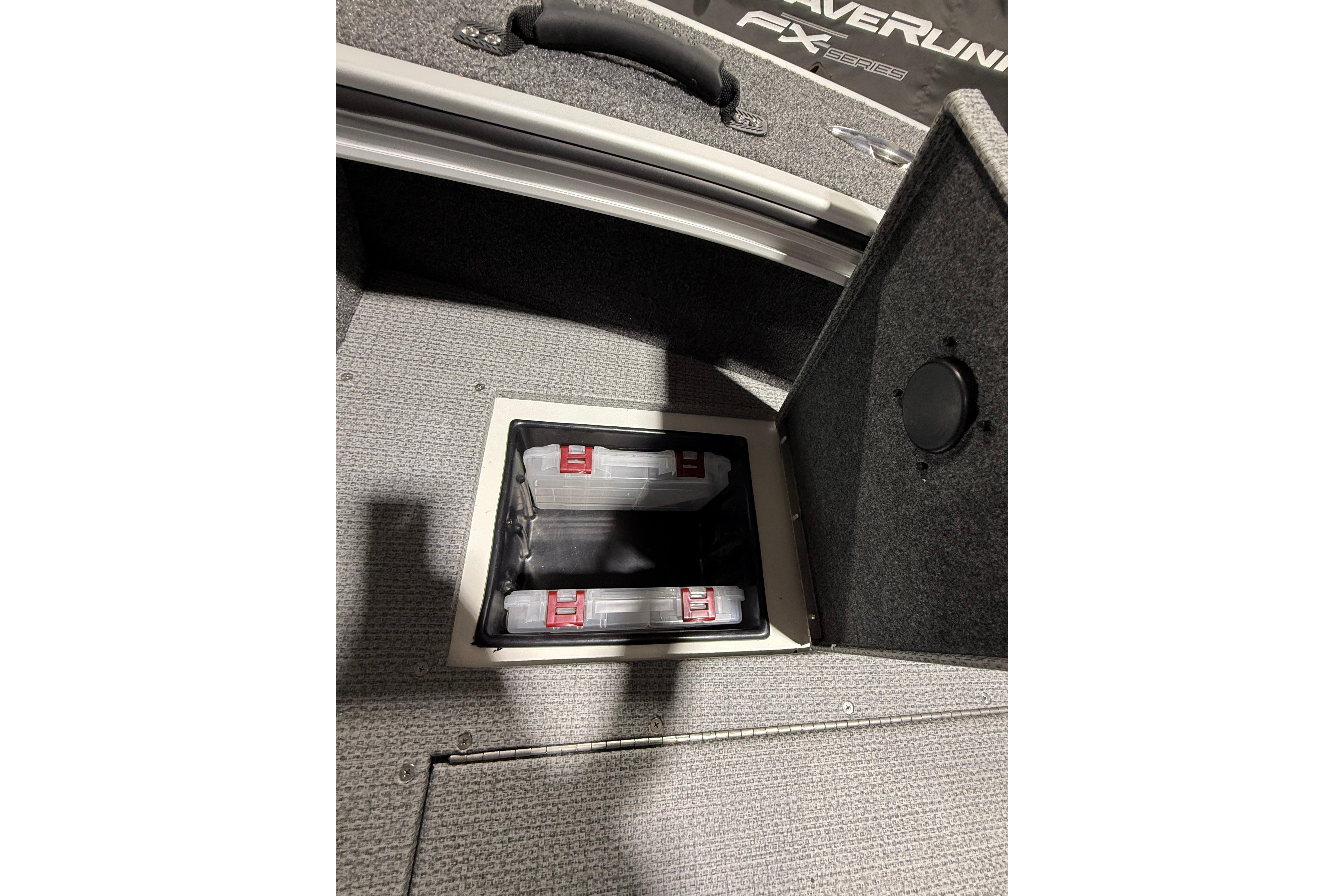 2025 G3 Angler V1850 SF boat storage compartment with organized tackle boxes.